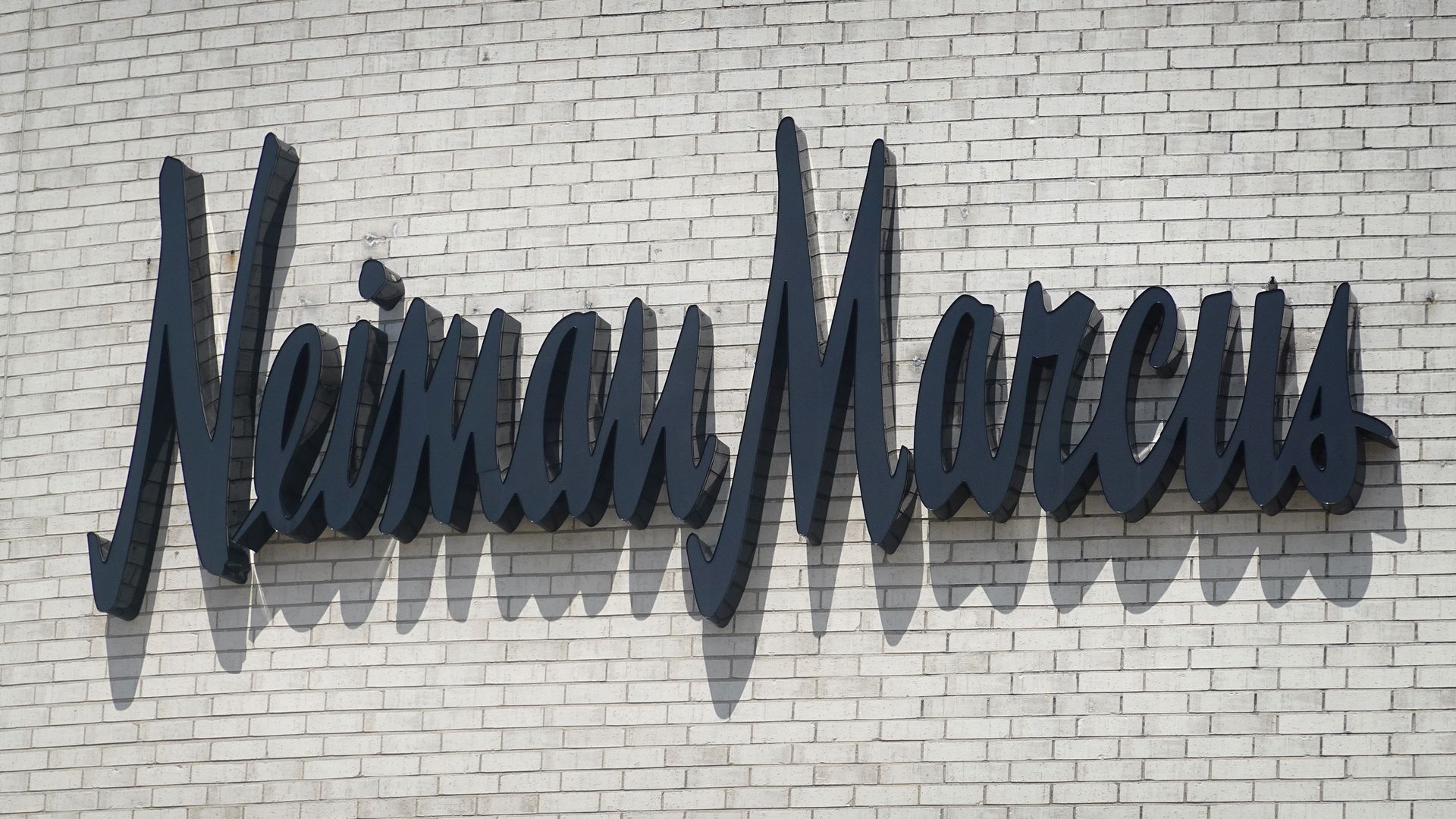 A sign hangs outside of a Neiman Marcus store.