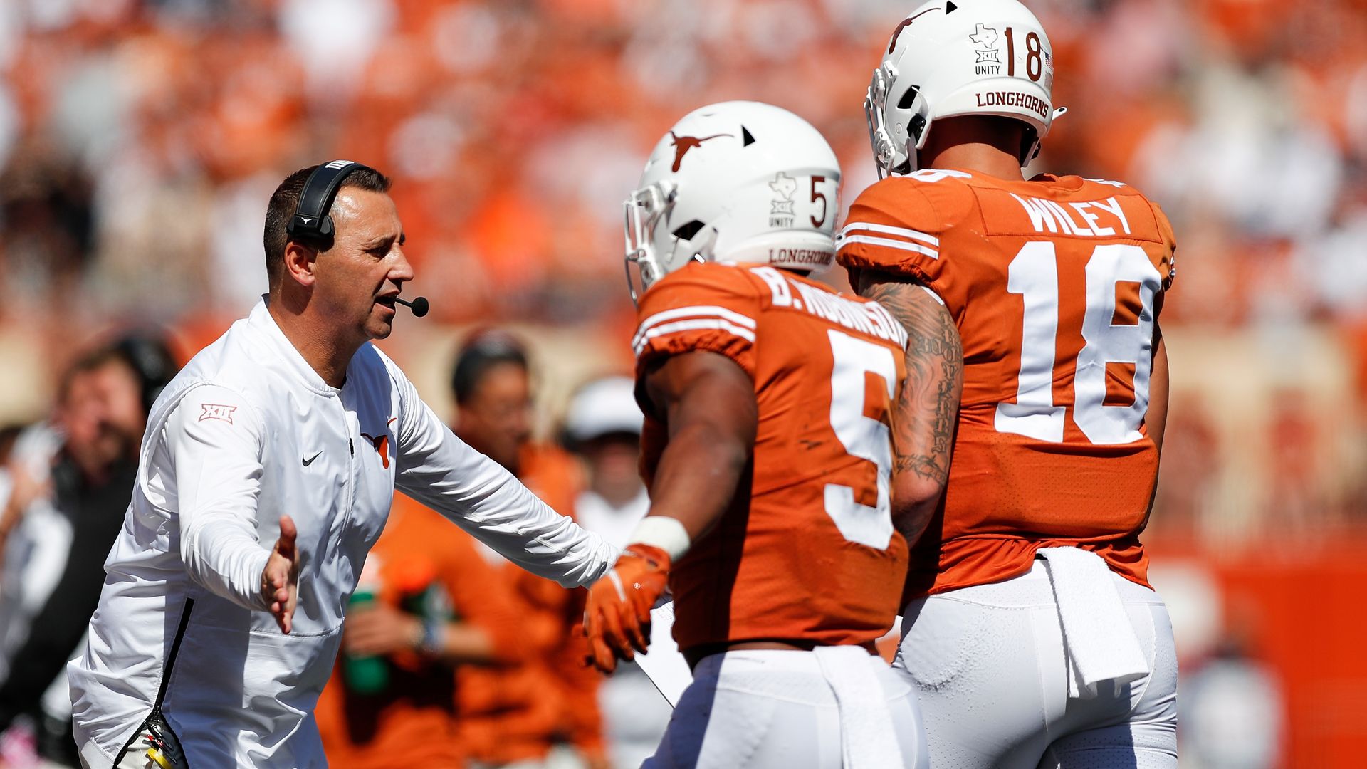 UT football coach Steve Sarkisian greets his players.