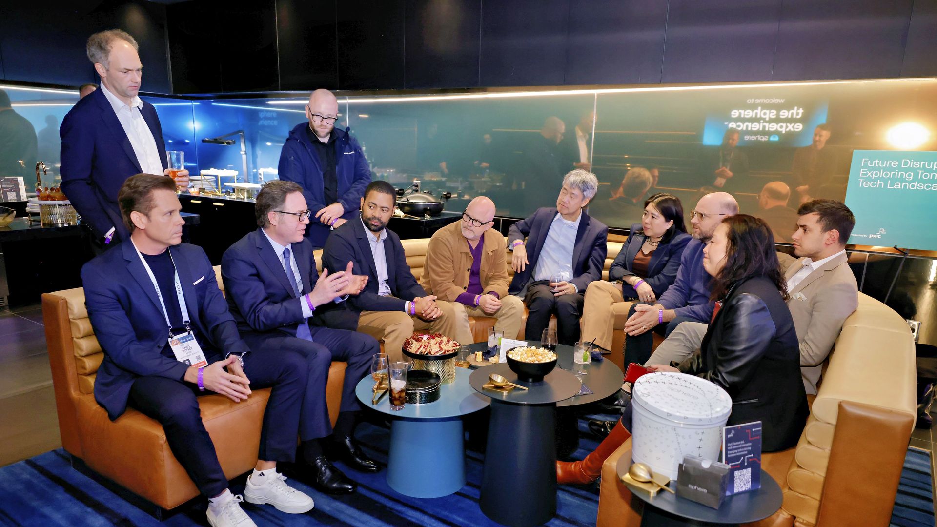 Attendees gathered in a sleek and intimate event venue space for an evening of networking and conversation. 