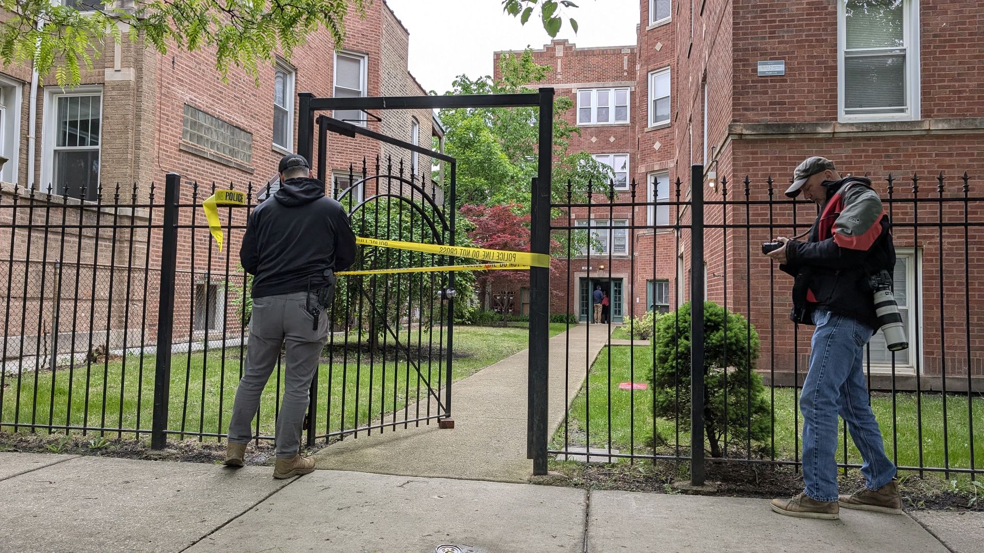 Photo of police tape being put up outside an apartment. 