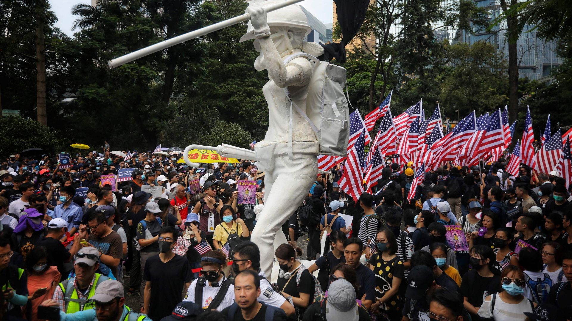 Protesters wave US national flags as they march from Chater Garden to the US consulate in Hong Kong on September 8