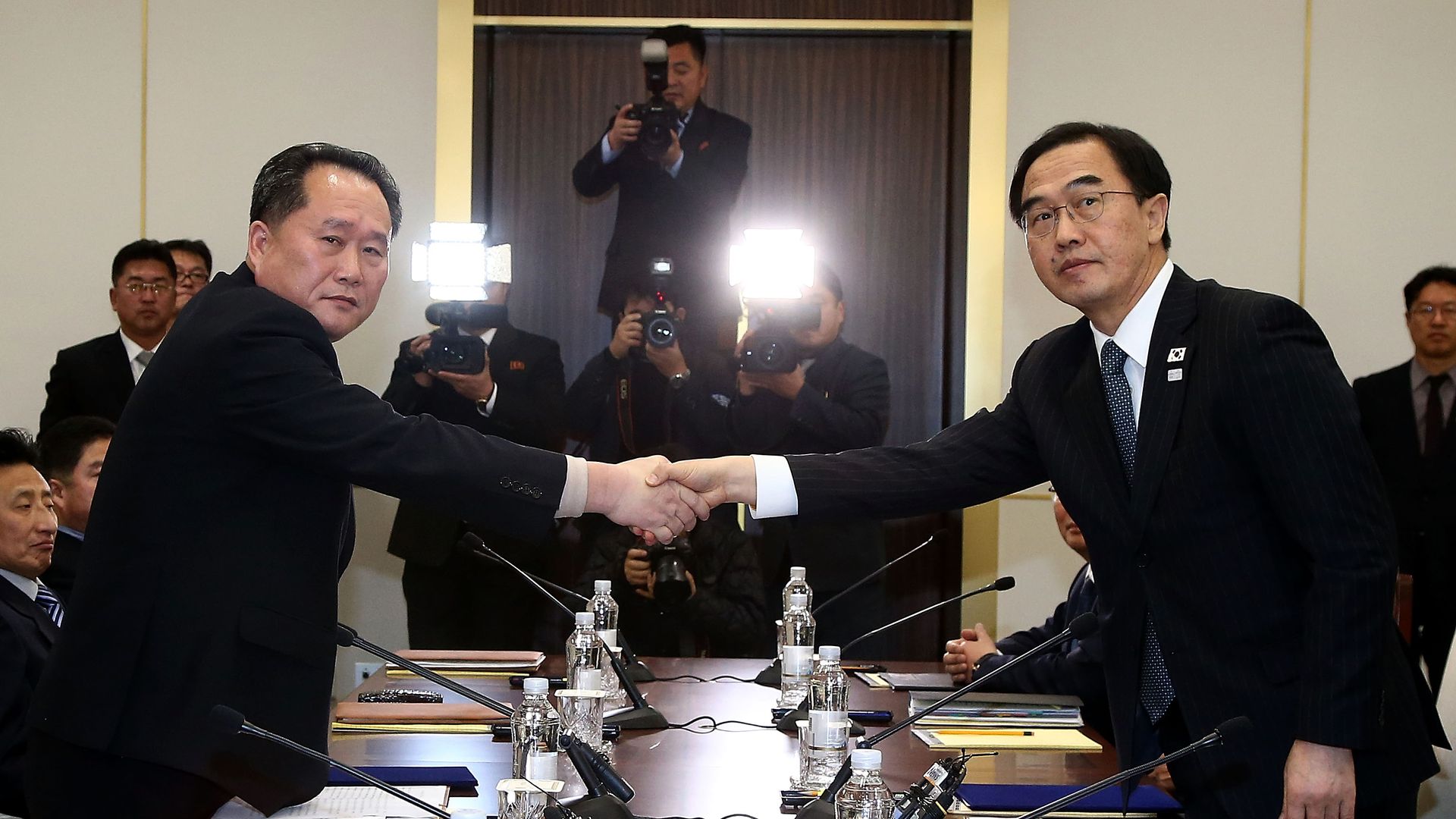 North Korea and South Korea delegation shake hands in Panmunjom.