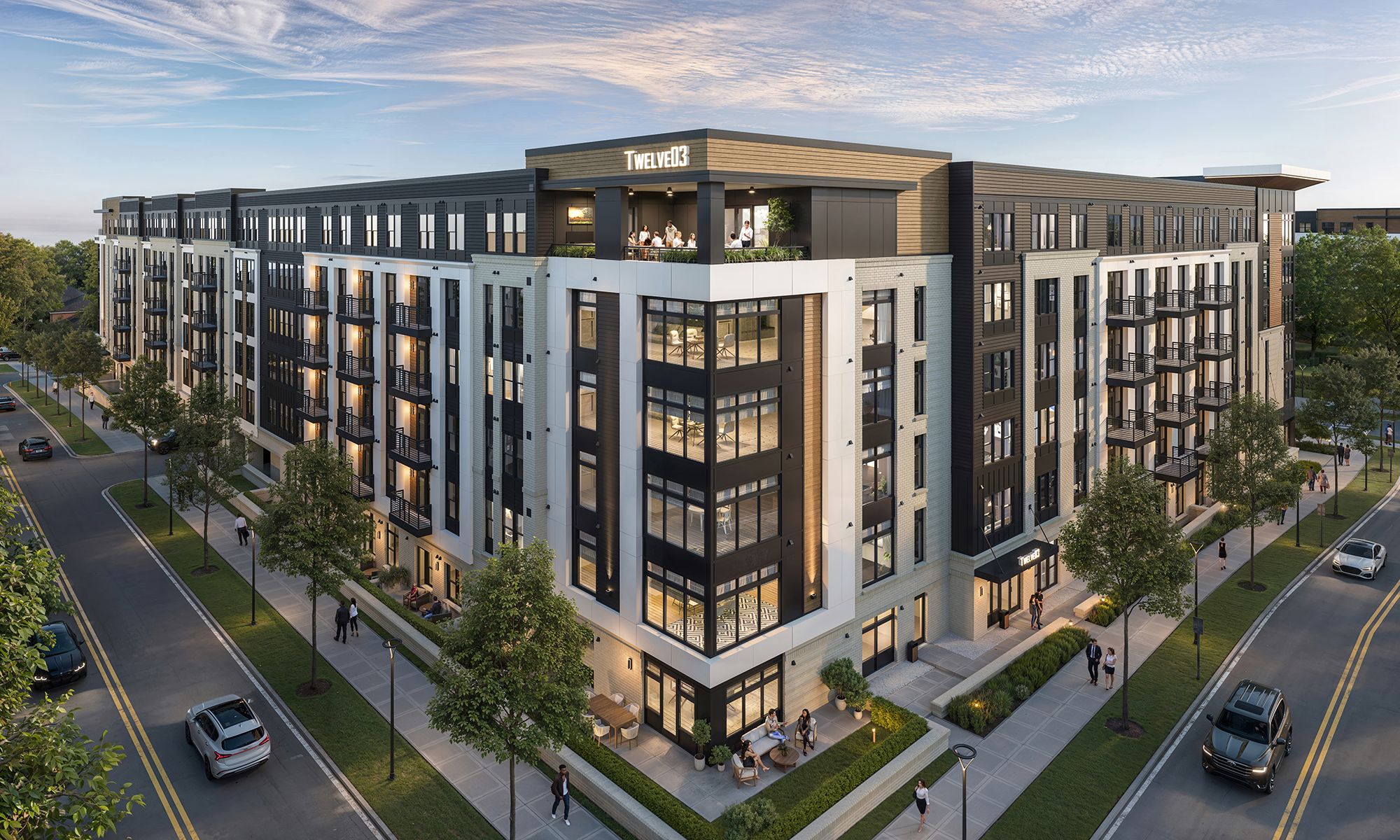 Modern four-story apartment building labeled TWELVE03 with large windows, balconies, and outdoor seating; people walk on sidewalks and drive cars on adjacent roads.