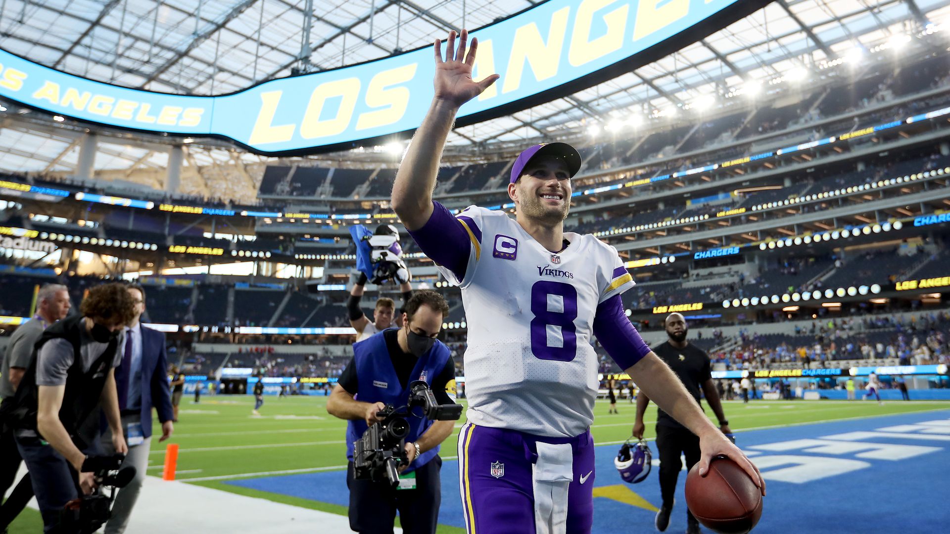 Kirk Cousins walks off the field waving to fans 