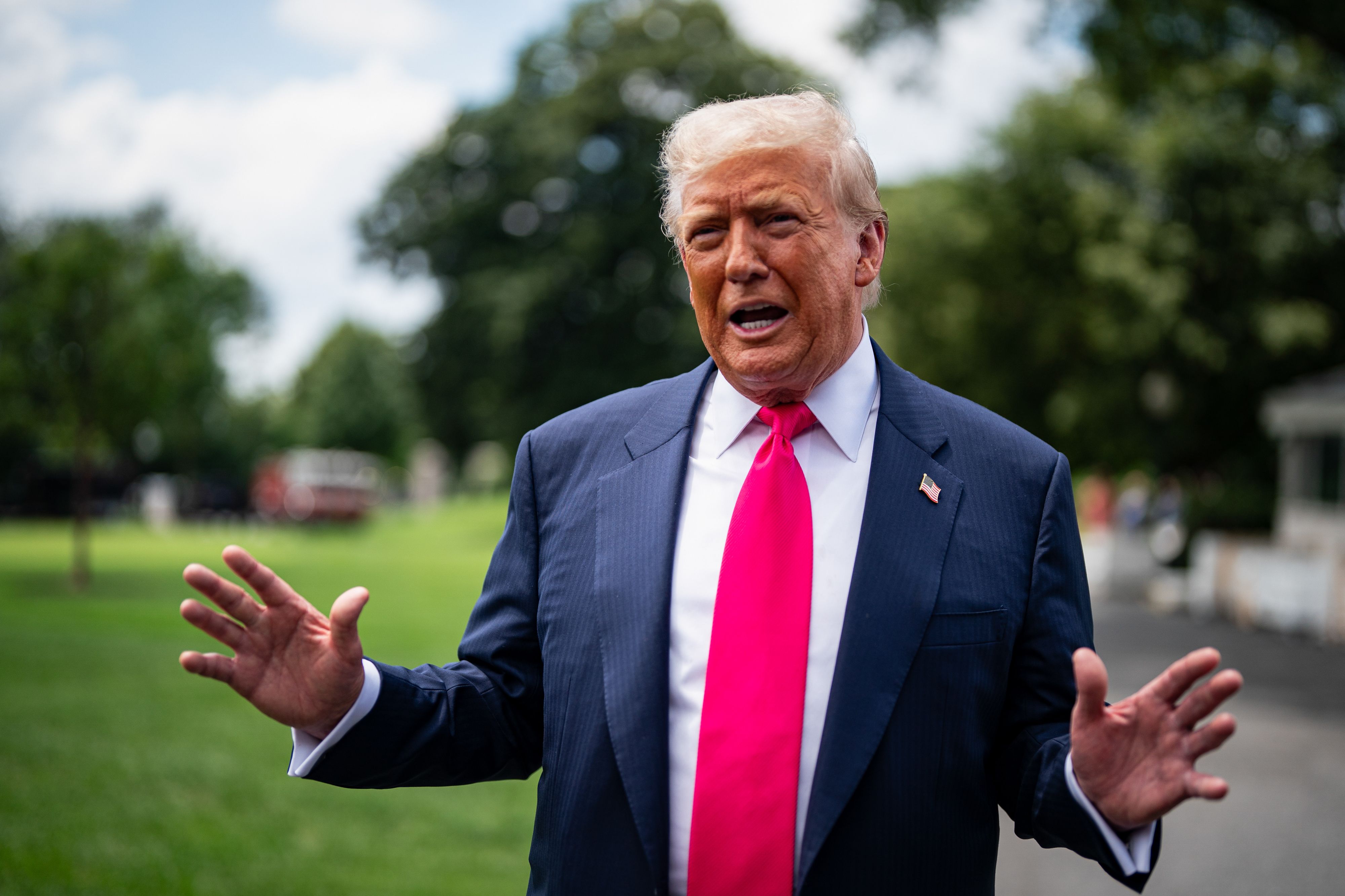 President Trump speaks to reporters on the South Lawn of the White House yesterday.