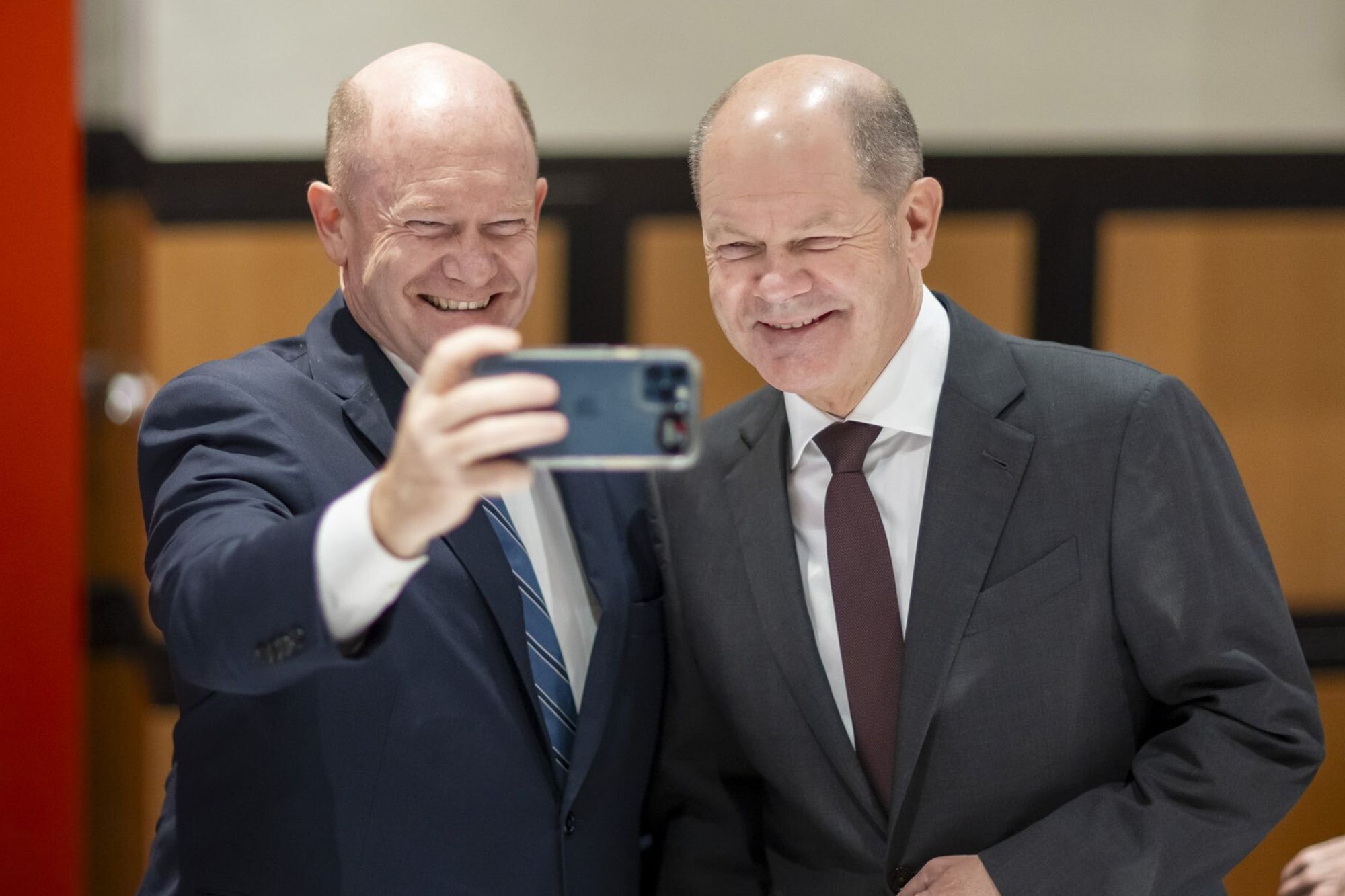 Sen. Chris Coons, D-Del., and German Chancellor Olaf Scholz pose for a selfie on X