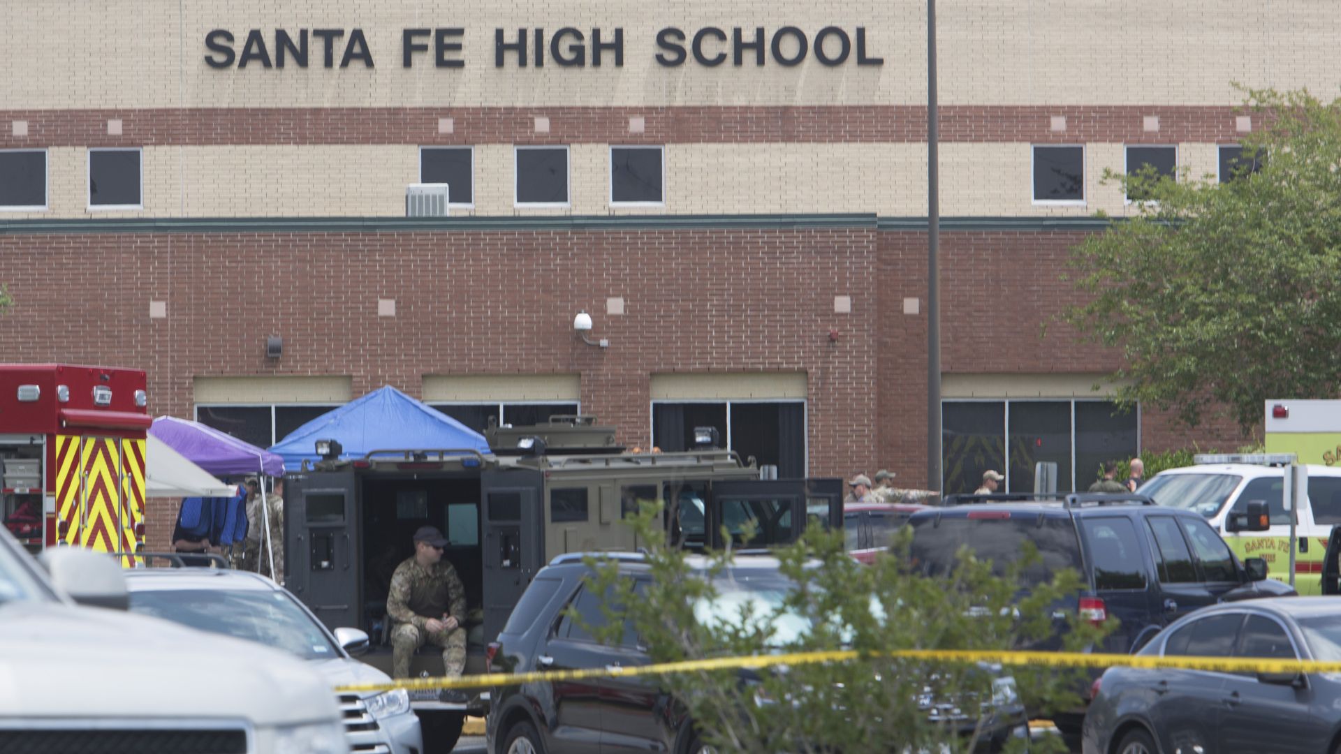 Emergency crews gather in the parking lot of Santa Fe High School