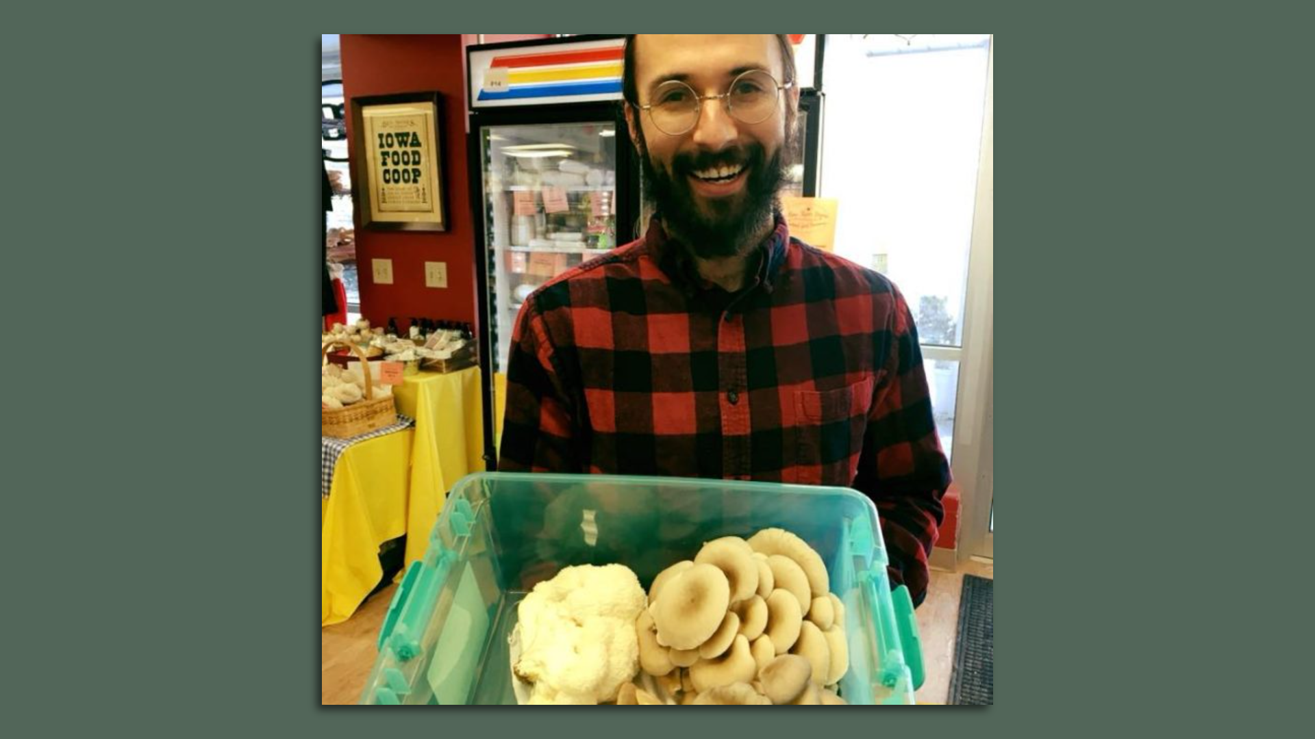 A photo of a man holding mushrooms.