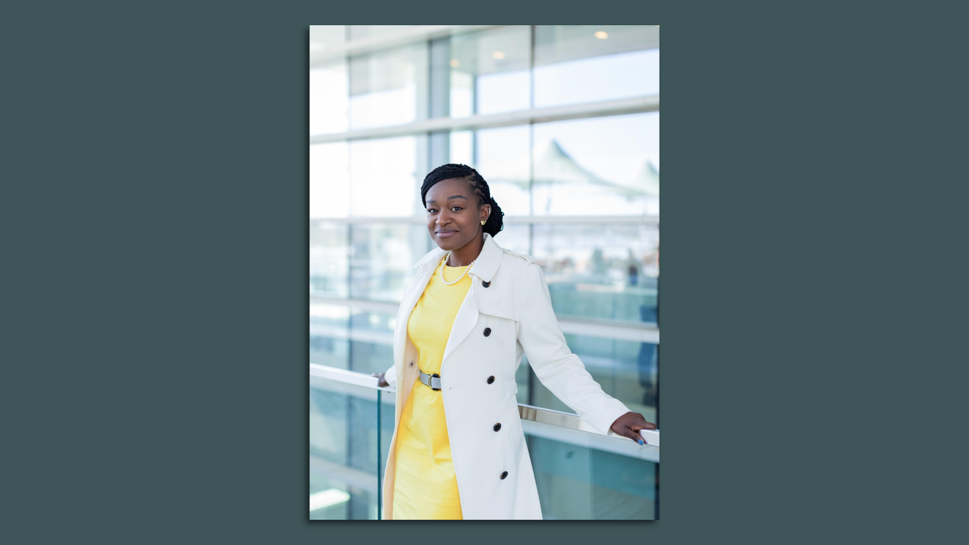 Photo of Camille Stewart Gloster in a white jacket leaning against a railing