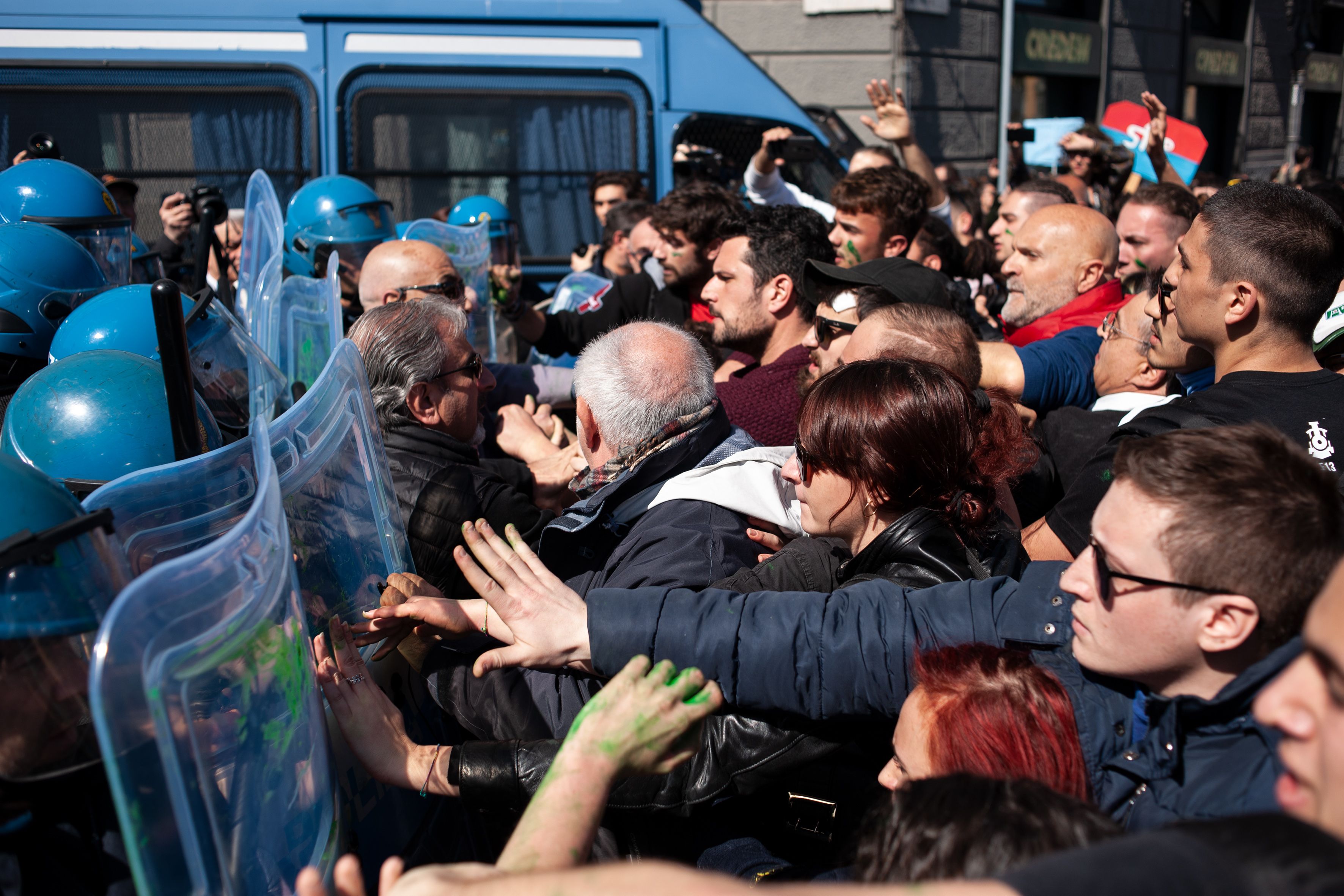 Protestors in Rome push against plastic riot shields. 