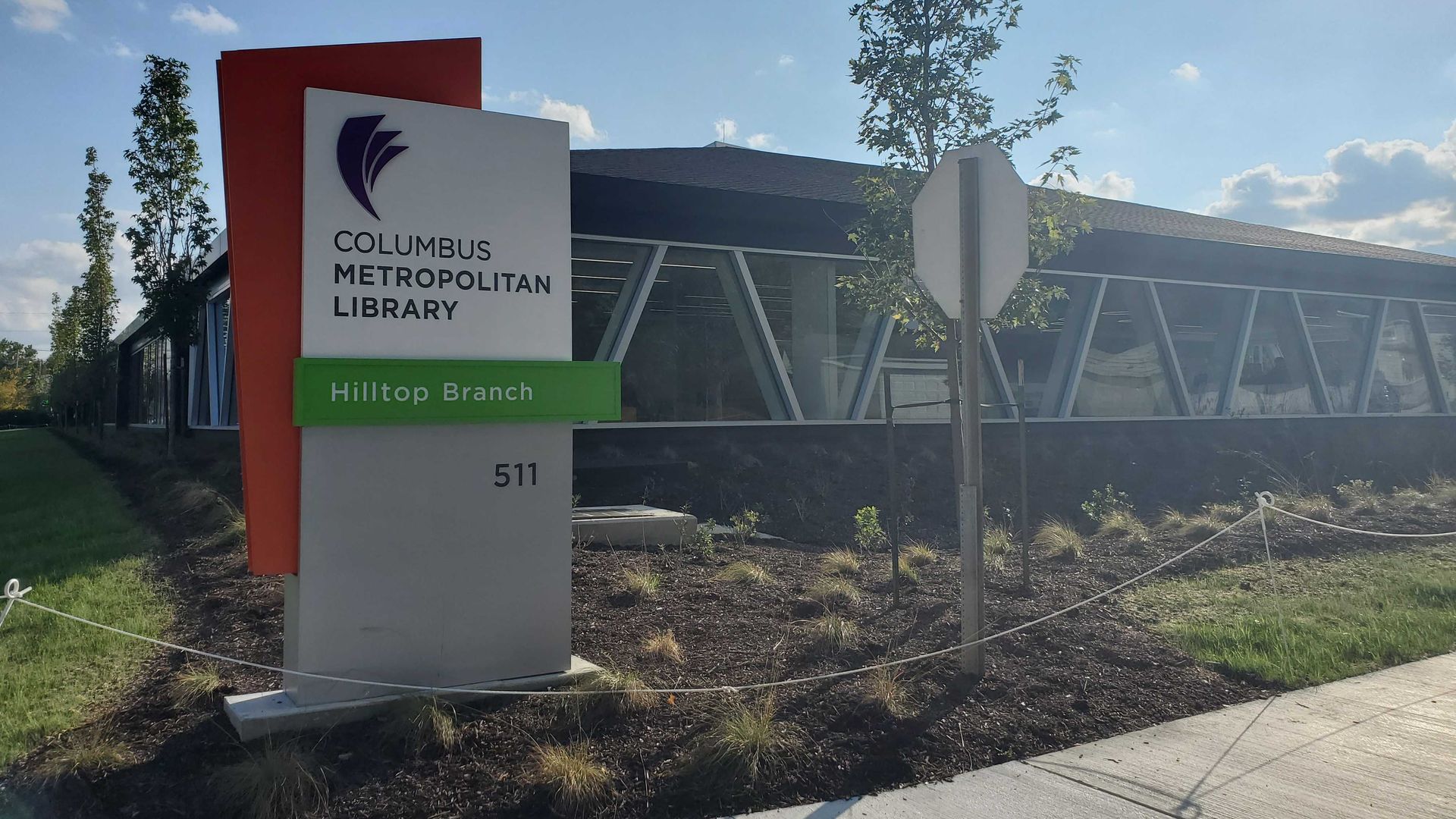A library sign reading "Columbus Metropolitan Library Hilltop Branch."