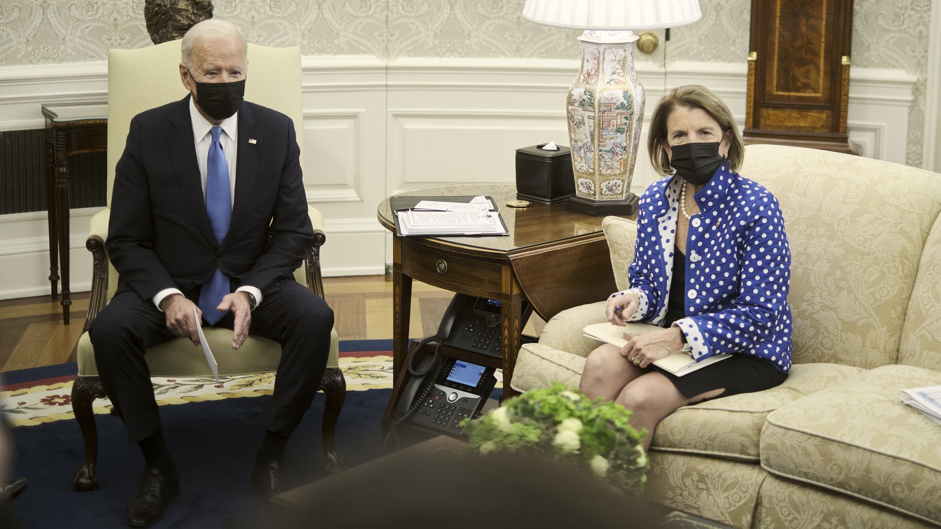 President Biden is seen sitting with Sen. Shelley Moore Capito in the Oval Office.