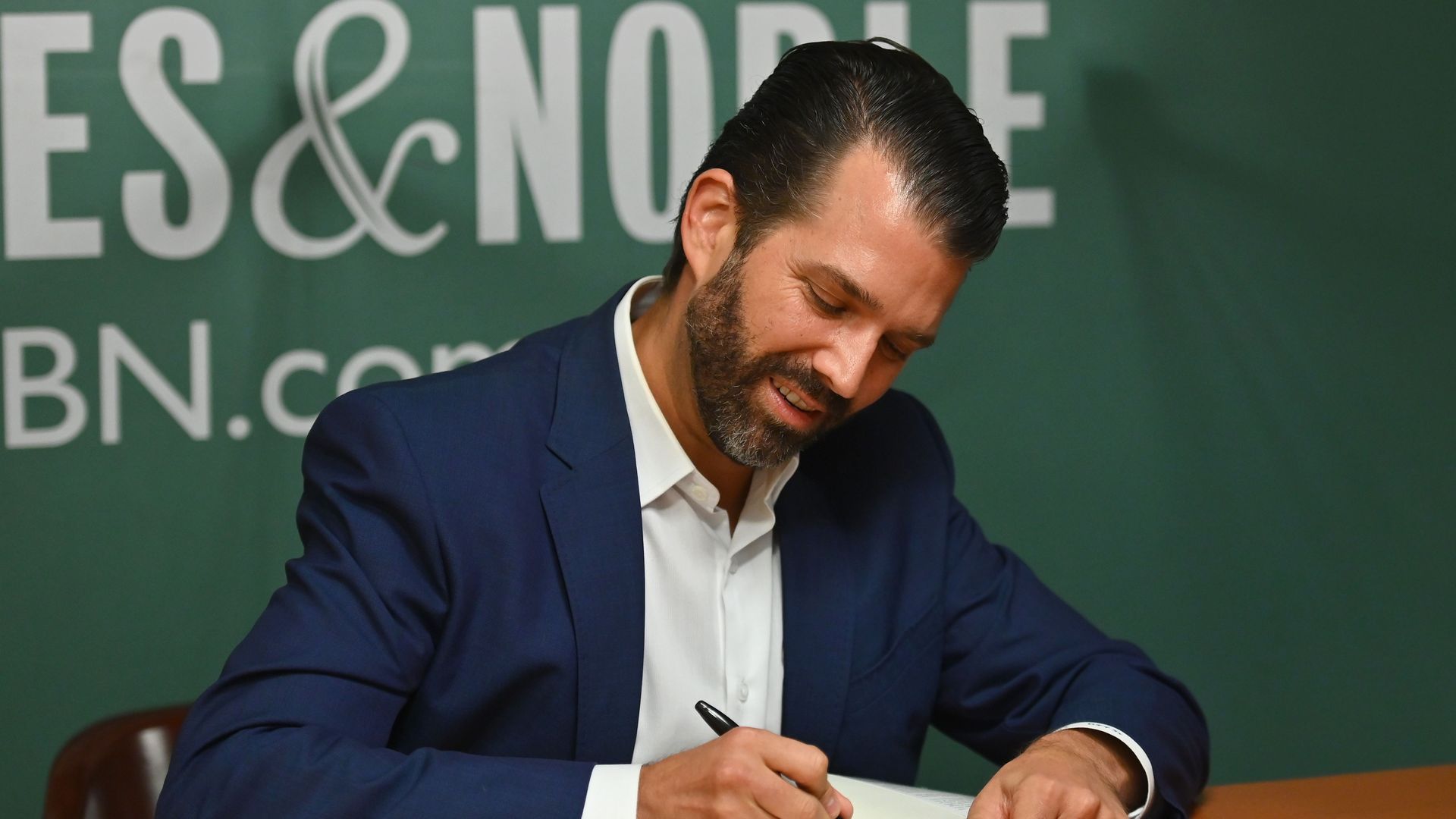 Donald Trump Jr. signs a copy of his book