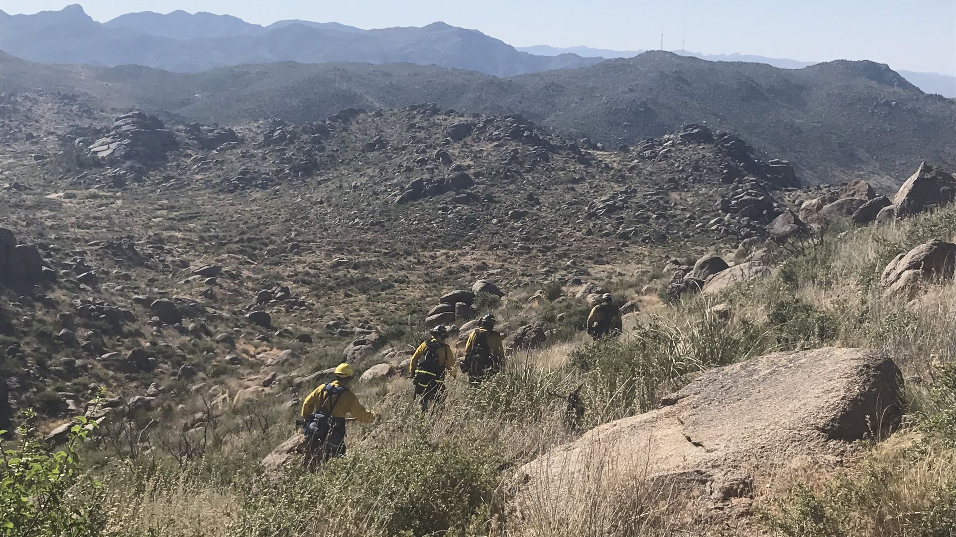 Firefighters on a hiking trail.