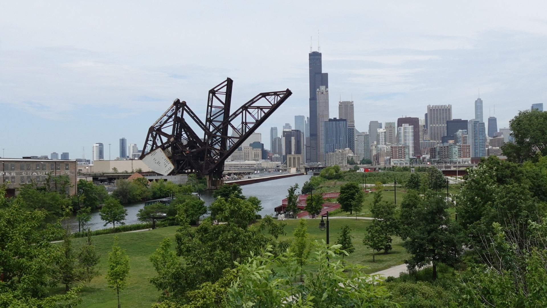 Photo of a skyline with a bridge in front of it. 