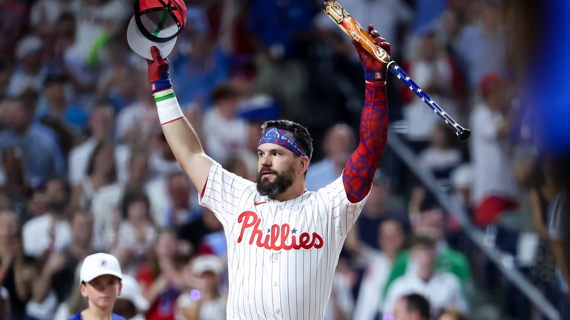 The Phillies Kyle Schwarber raises his arms in celebration during the Home Run Derby.