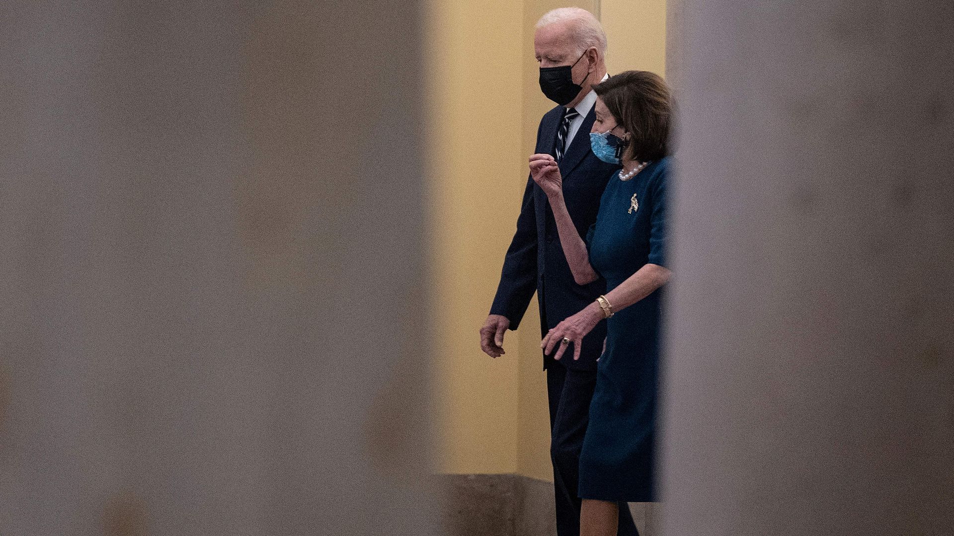 President Biden is seen walking with House Speaker Nancy Pelosi after meeting with House Democrats on Thursday.