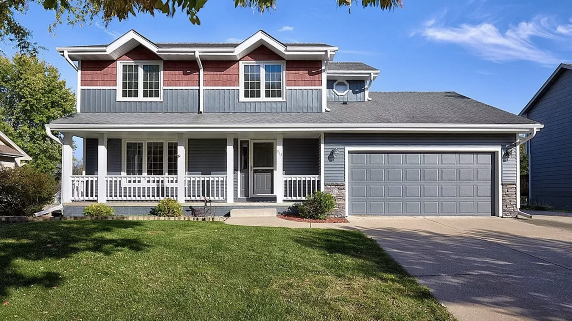 A photo of a two-story house with a front porch in Des Moines.