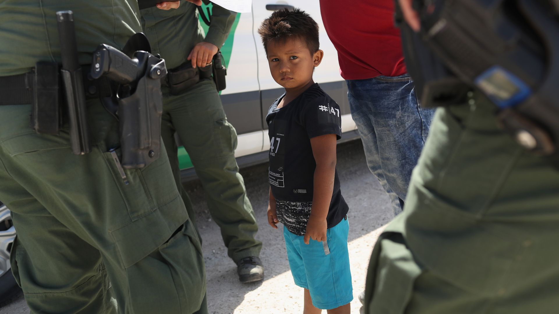 Border agents take a child into custody in Texas