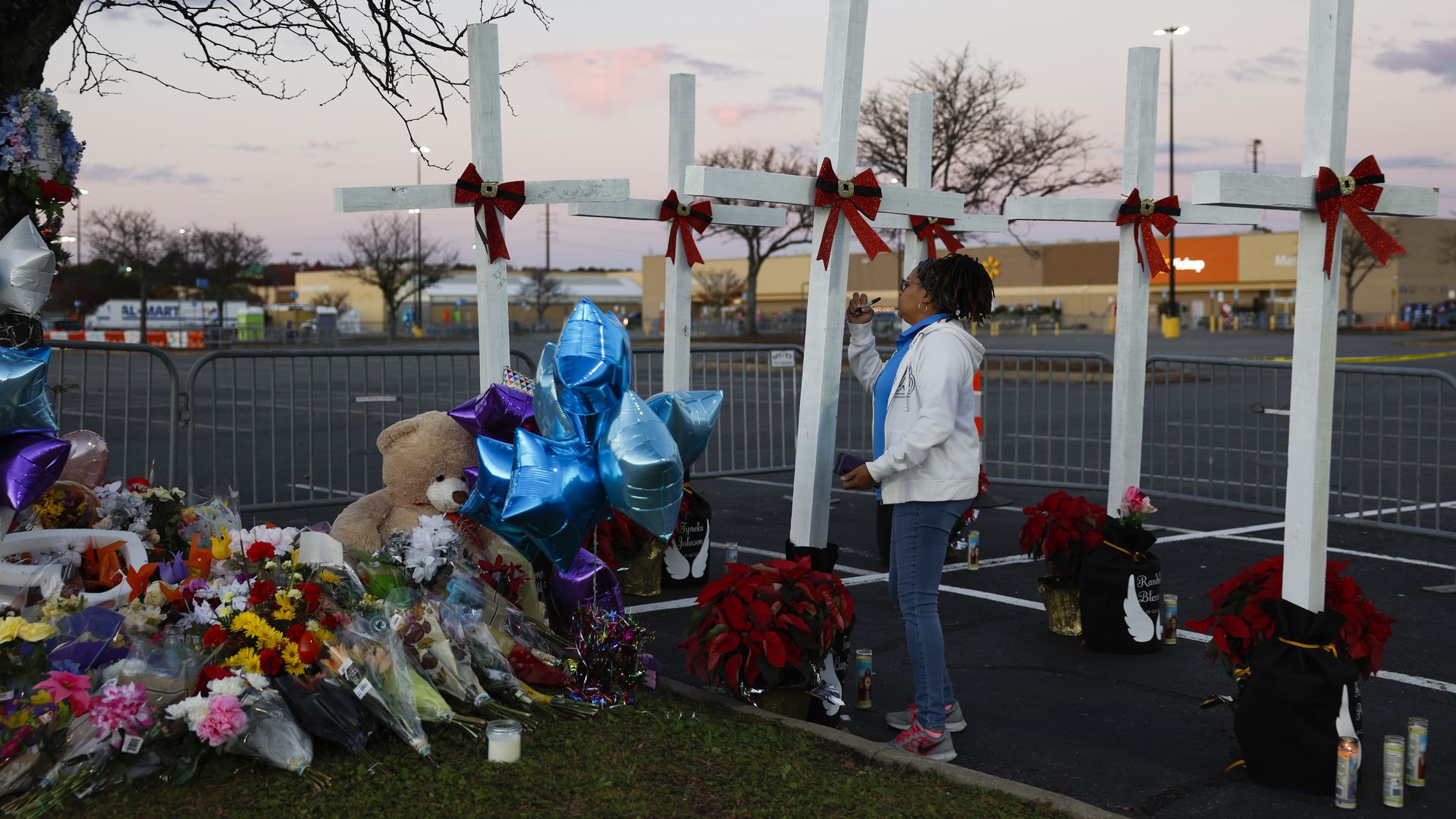 A person tending to a memorial outside the Walmart in Chesapeake, Virginia, on Nov. 28.