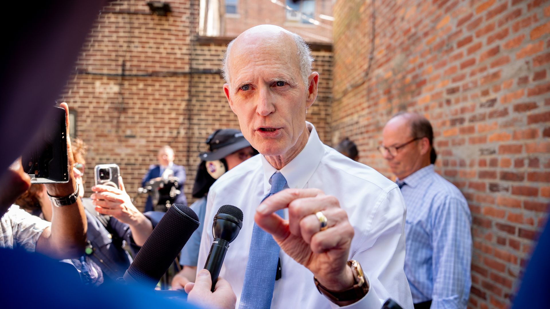 Sen. Rick Scott (R-FL) speaks to members of the media during a rally 