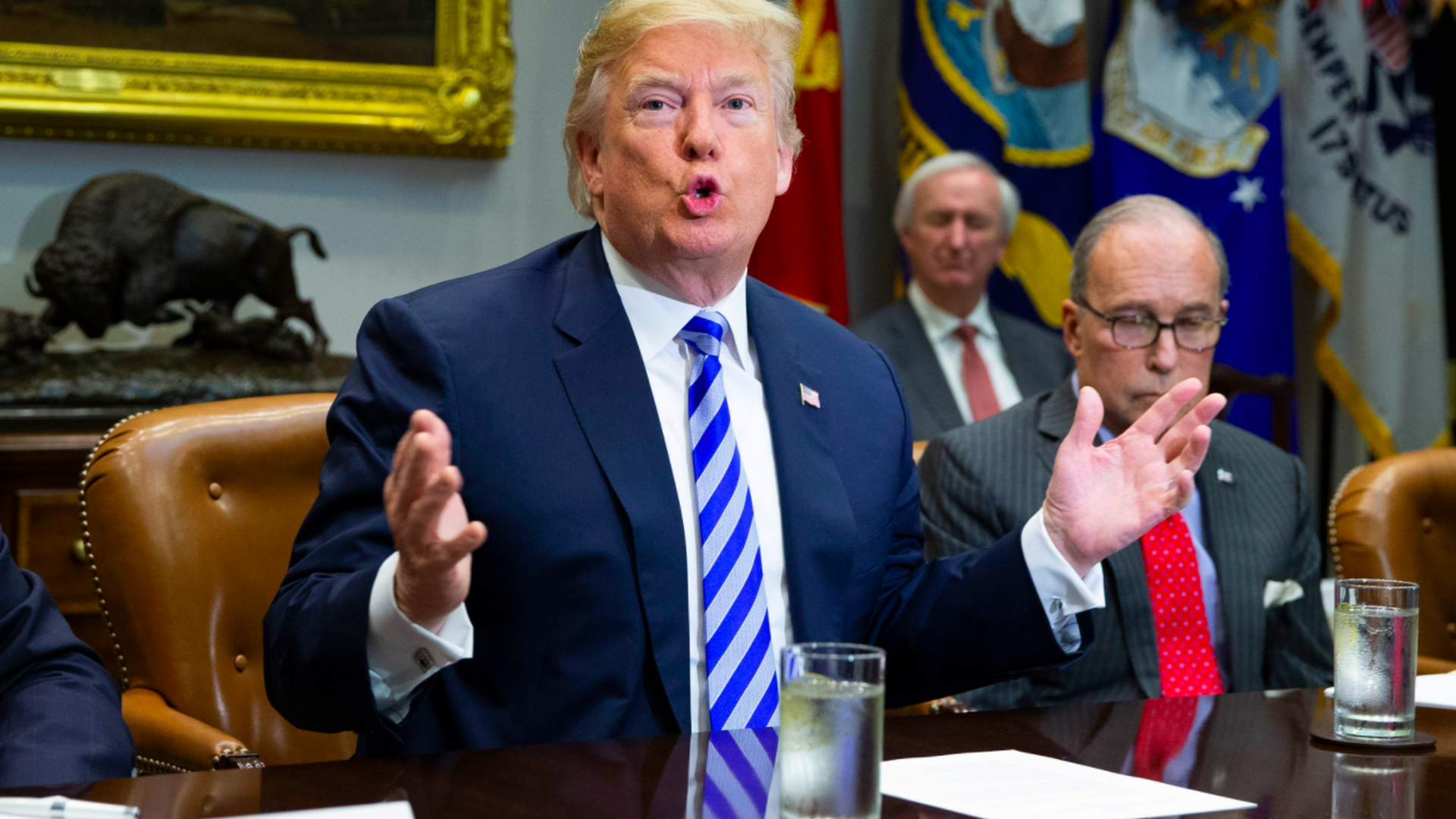 Trump gestures at a meeting