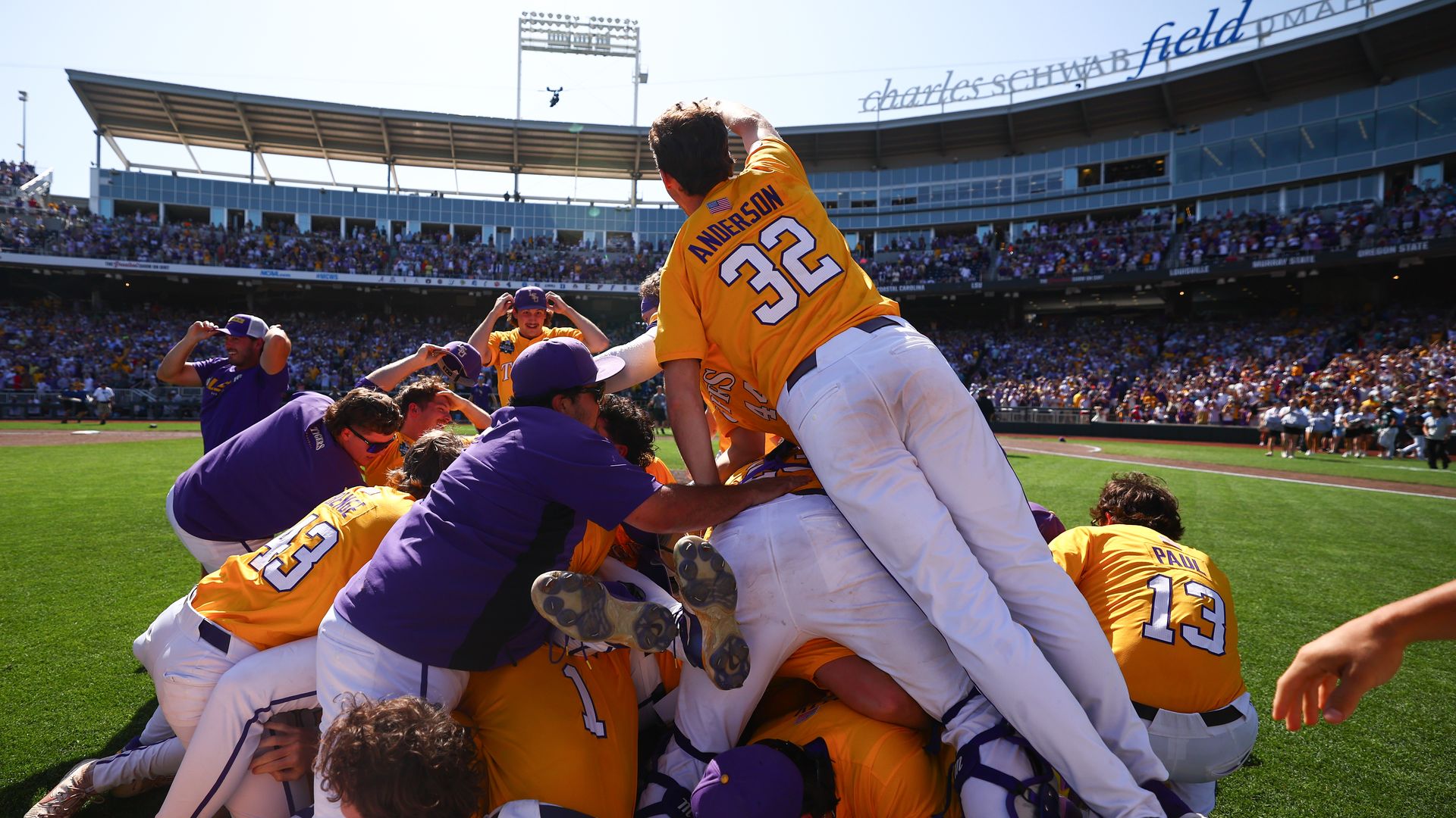 LSU Tigers baseball players dog-pile at centerfield.