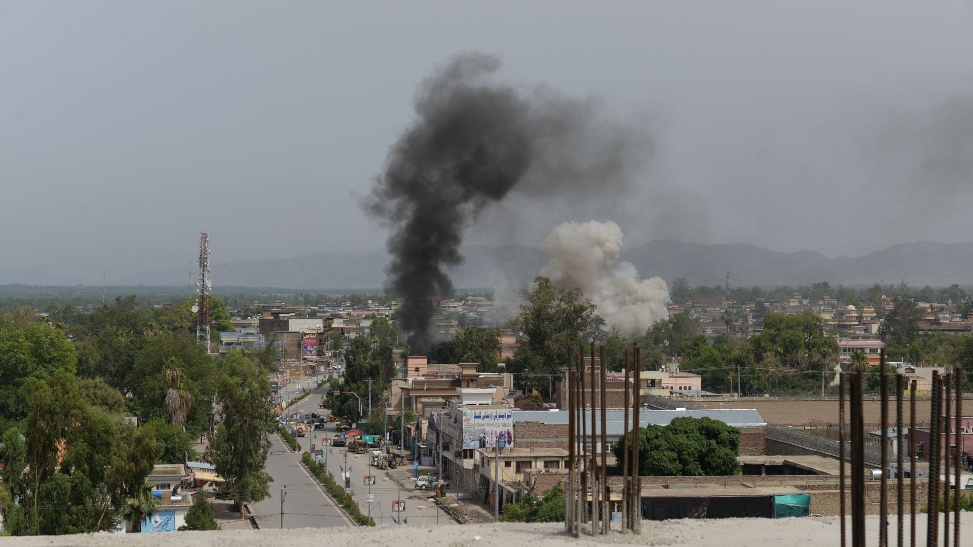 Smoke rises from a building during an ongoing attack between Afghan security force and suicide attackers at a government building in Jalalabad on May 13, 2018. 