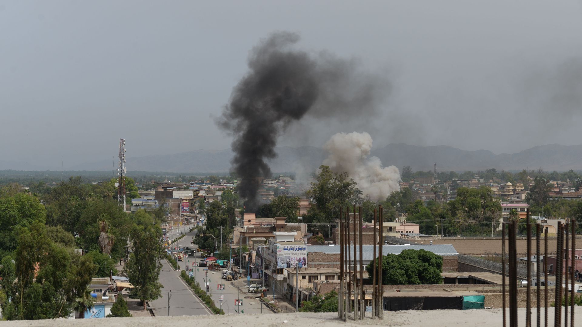 Smoke rises from a building during an ongoing attack between Afghan security force and suicide attackers at a government building in Jalalabad on May 13, 2018.
