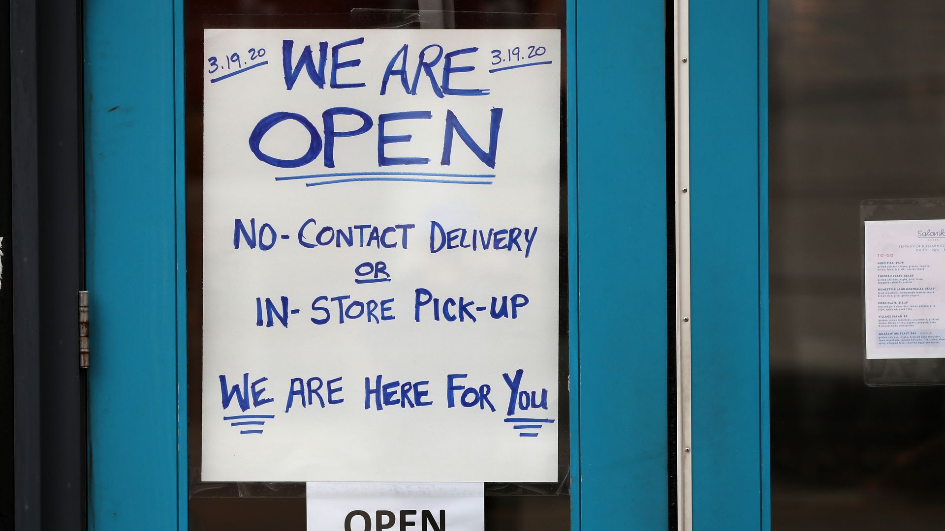 Restaurant posts "open" sign during coronavirus pandemic
