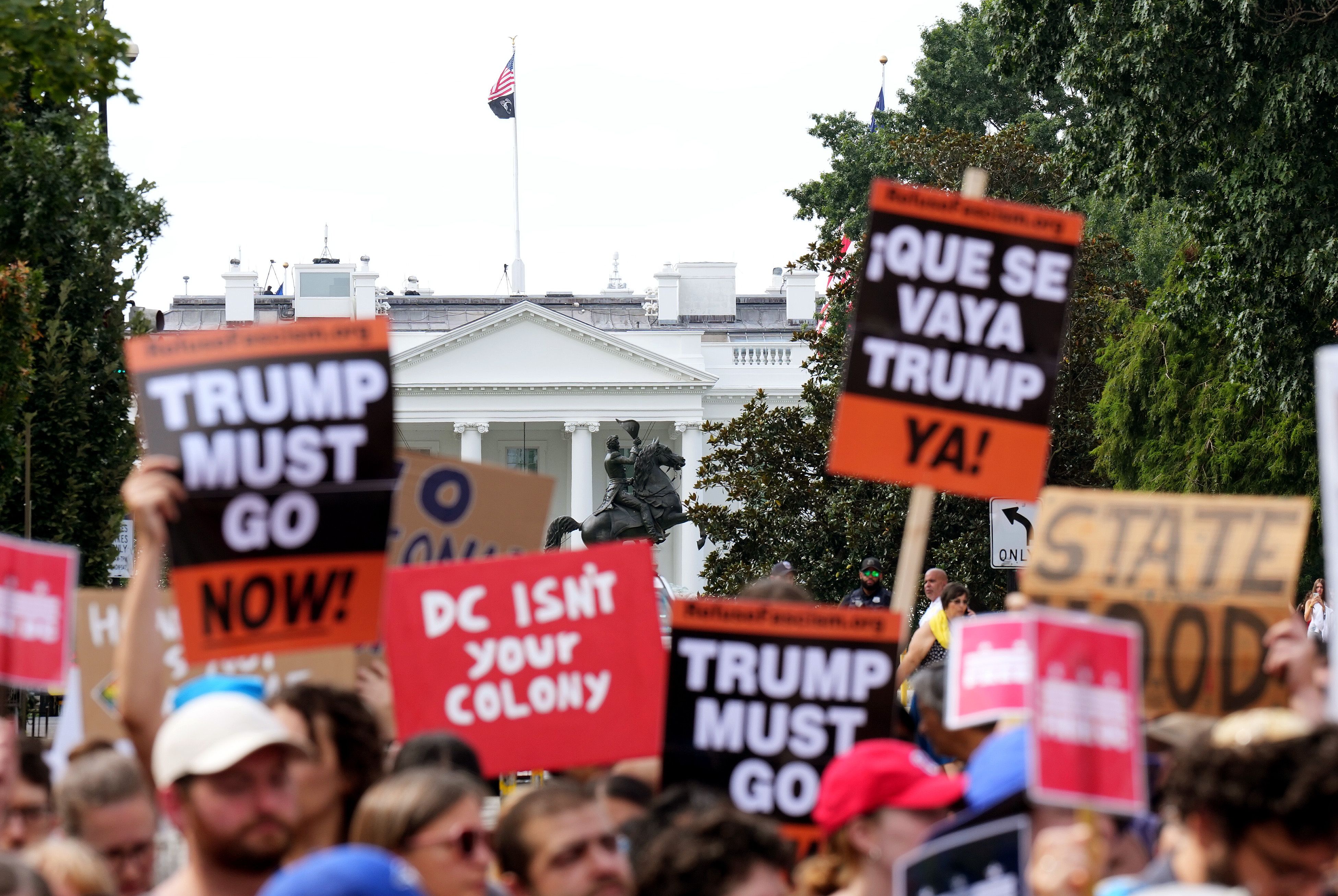 People participate in a rally against the Trump Administration's federal takeover of the District of Columbia.