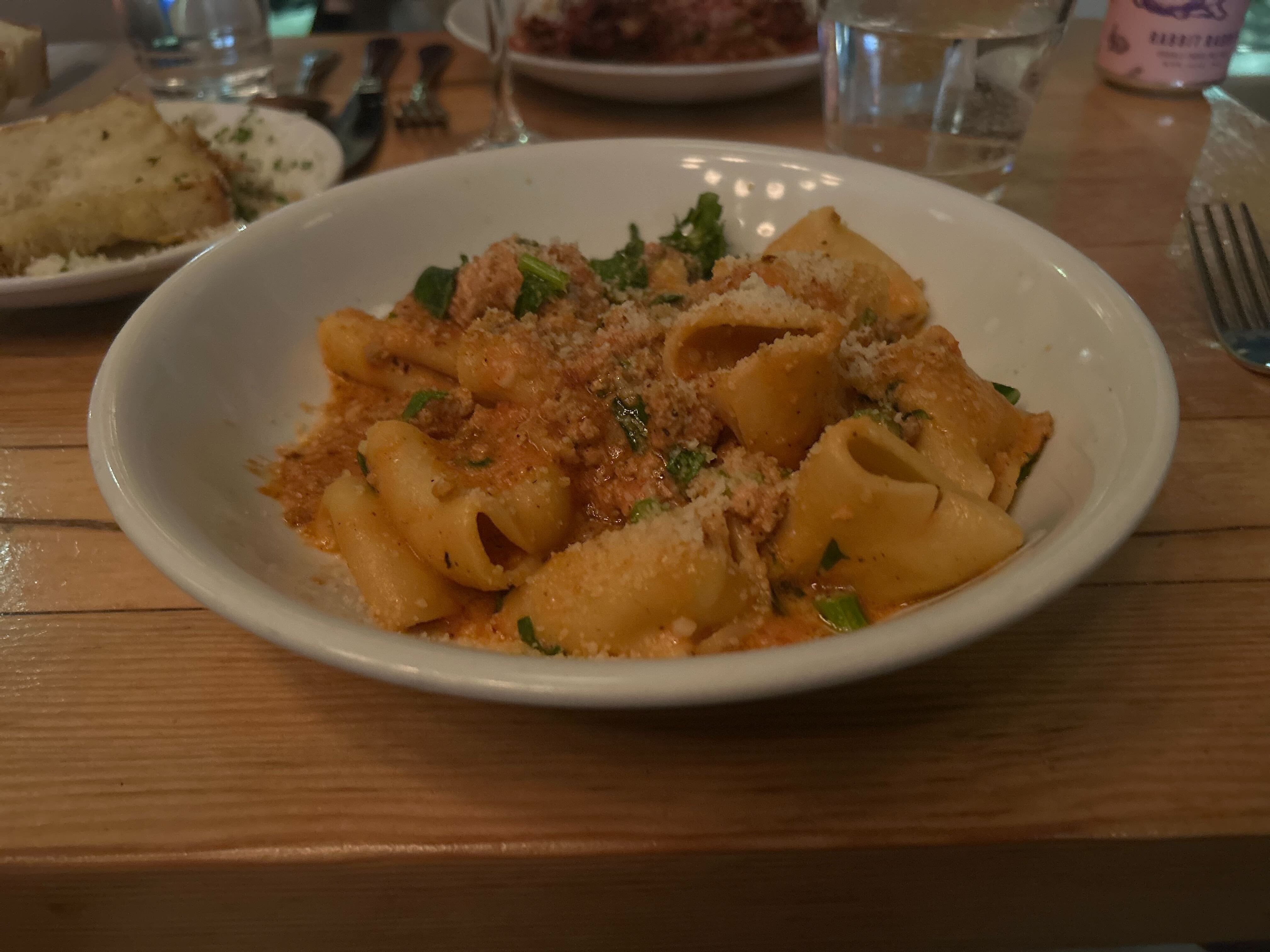 A bowl of paccheri bolognese, which has wide noodles and broccoli rabe, from MIDA in Boston's South End.