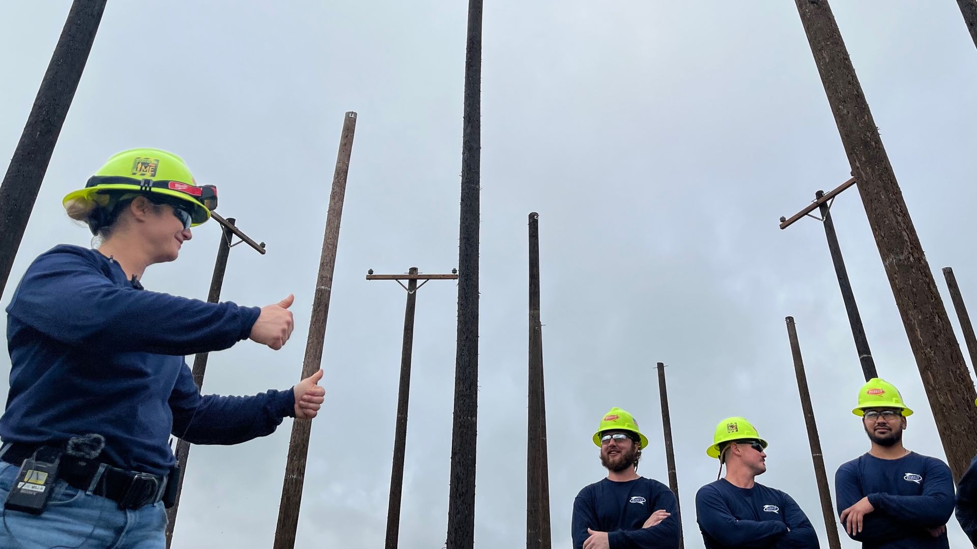 Cherie Rene Cheramie gives fellow lineworkers the thumbsup.