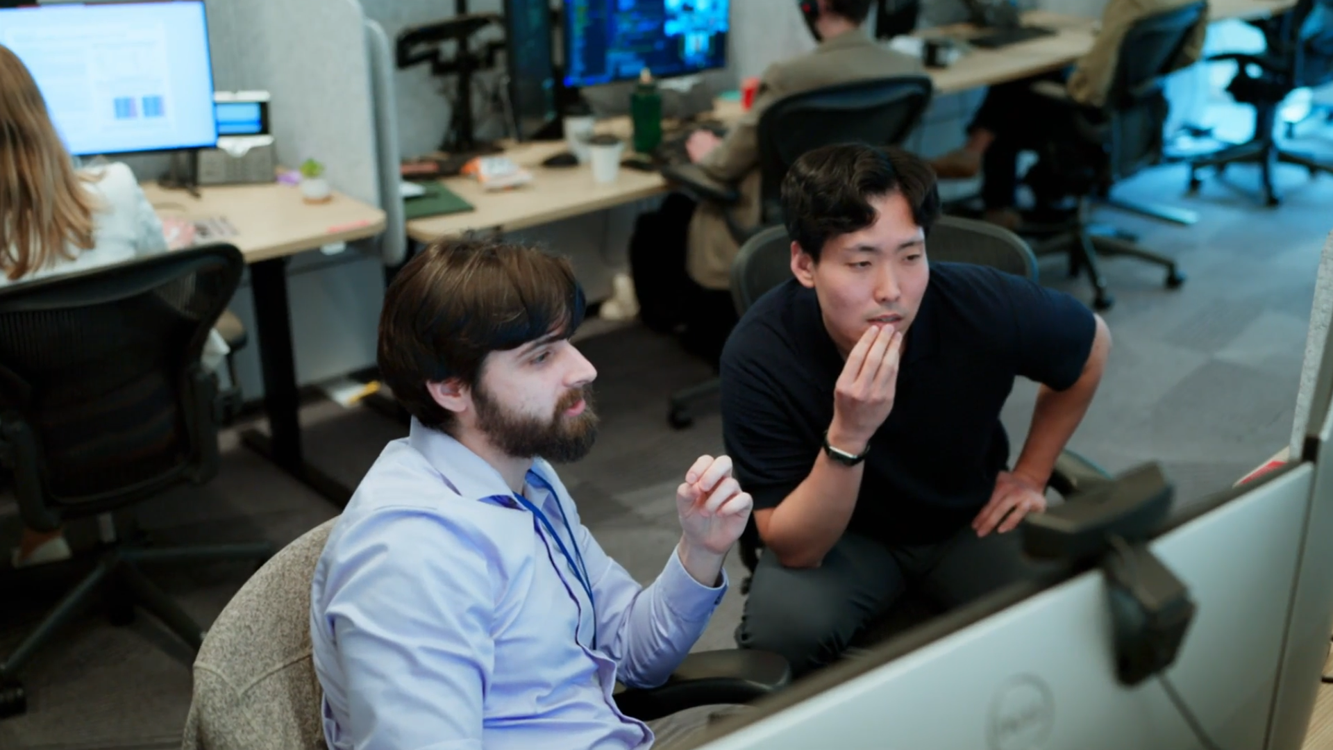 Two guys looking at a computer screen.