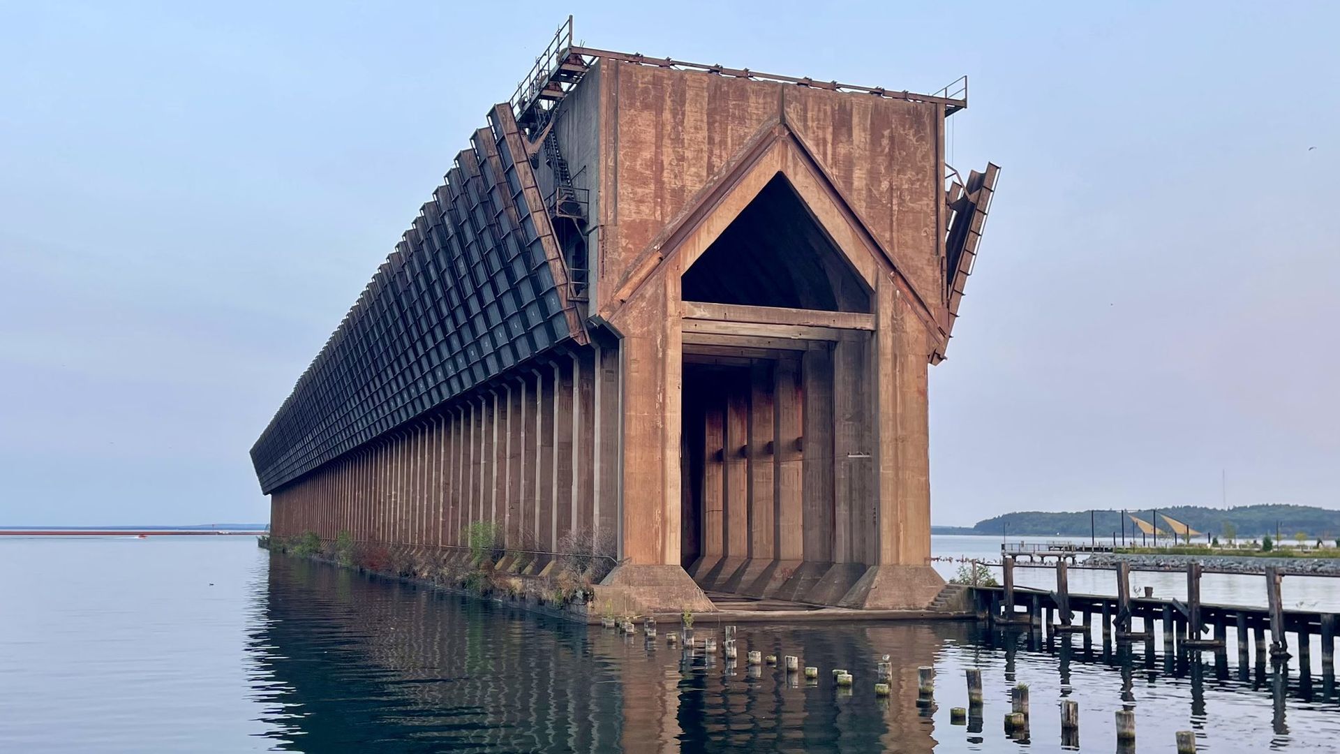 A rust colored structure sitting in the water