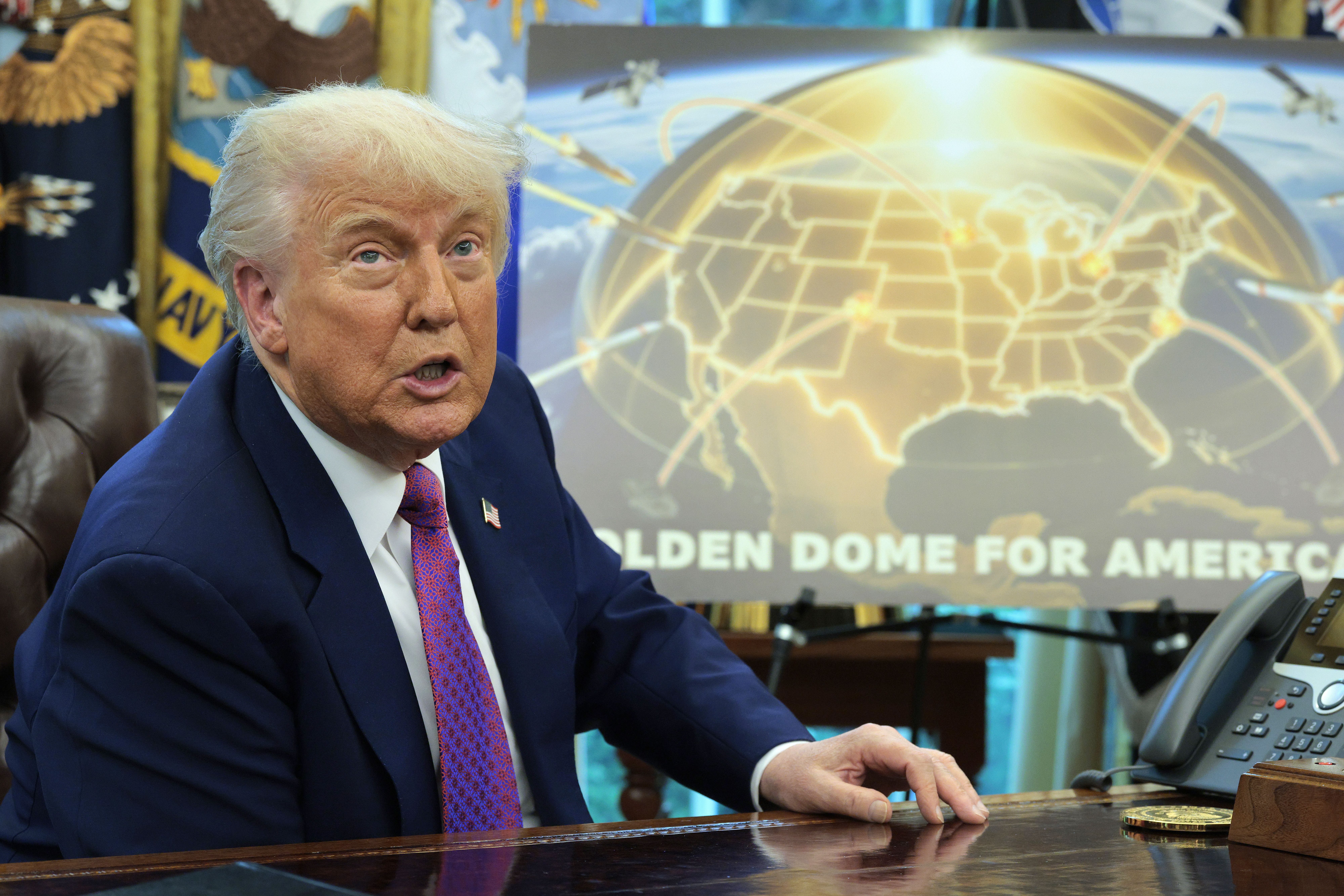 President Trump speaking before a map illustrating the Golden Dome missile-defense system.