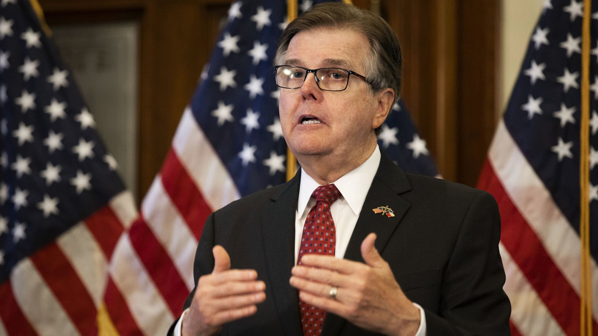 A photo of Texas Lt. Gov. Dan Patrick in front of American flags.