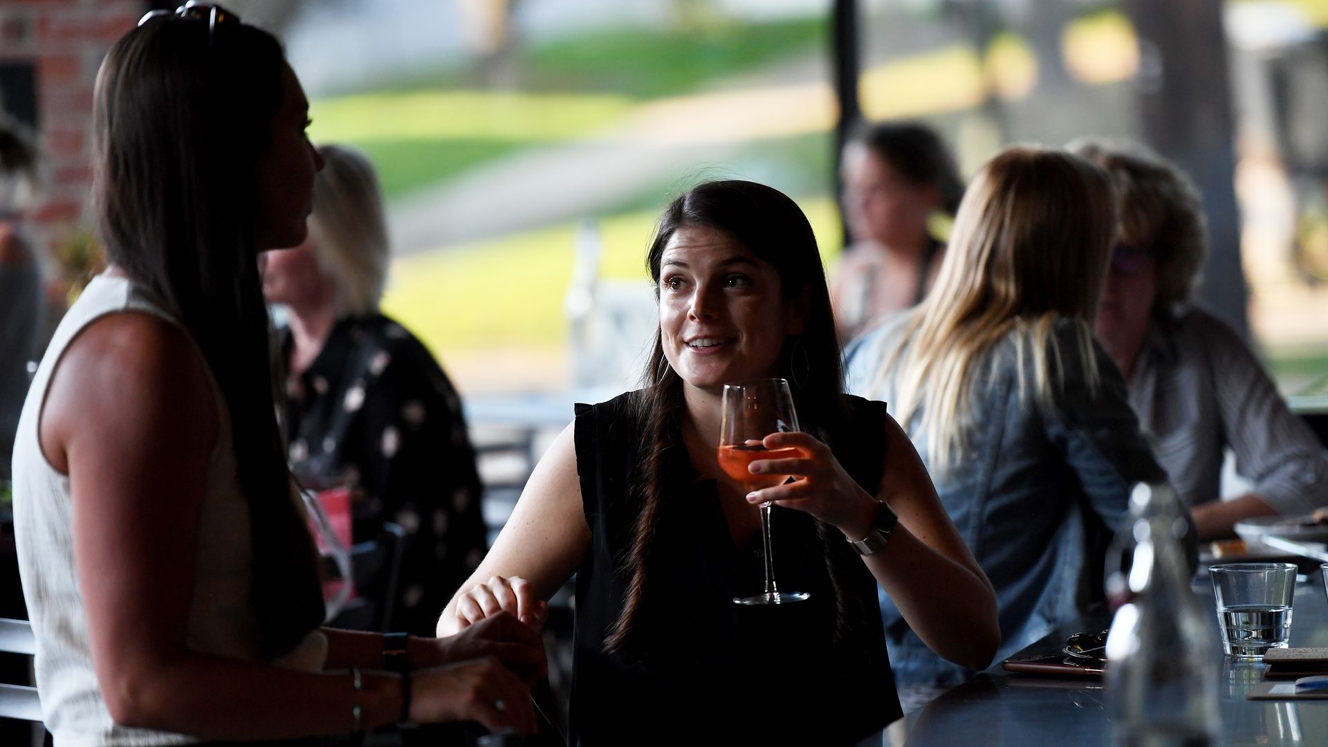 A patron talks with a friend at a restaurant in Denver in 2019.