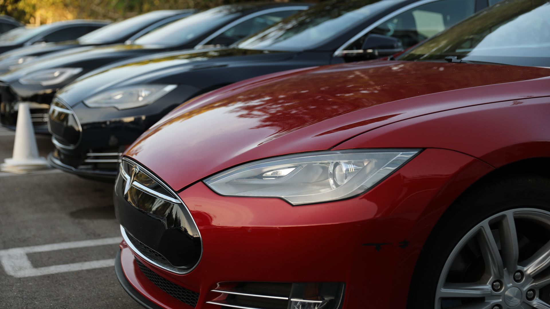 Photograph of a row of new Teslas at a dealership