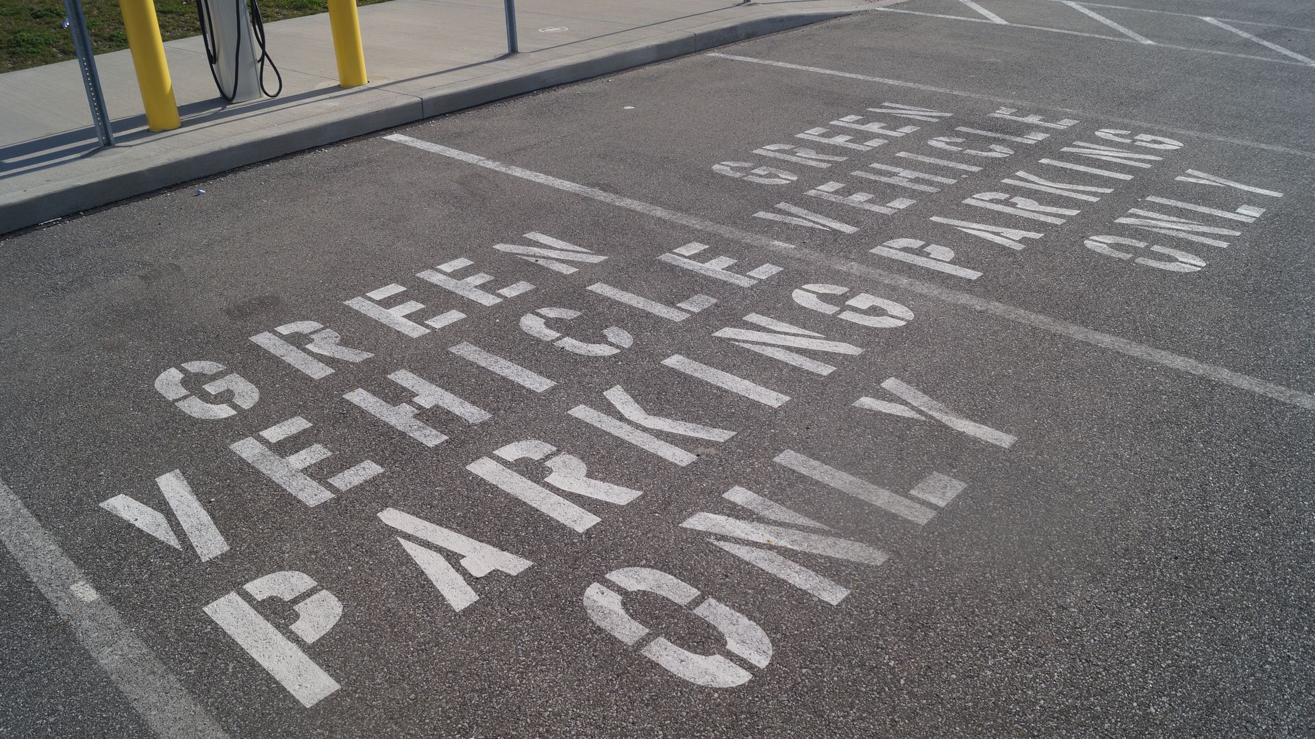 Image of parking space that reads "Green Vehicle Parking Only"