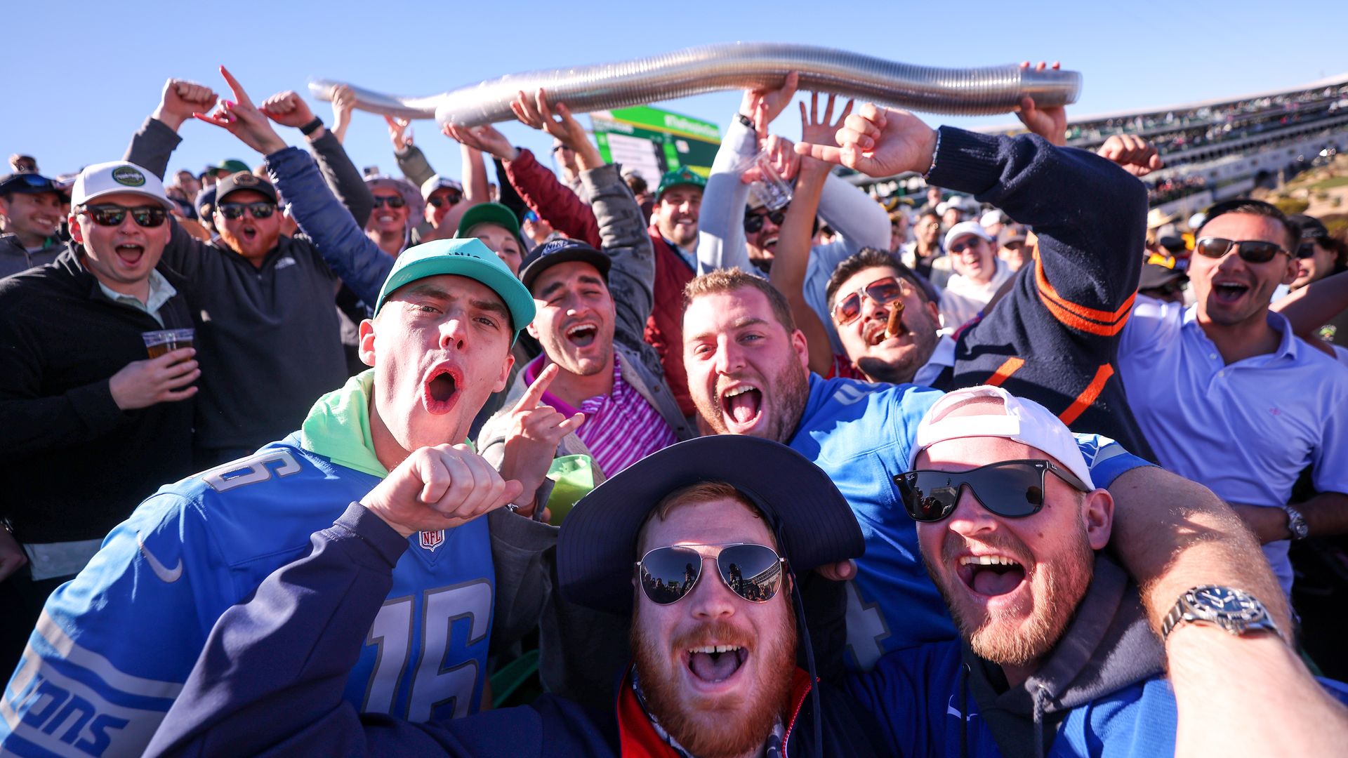 Fans cheering and stacking plastic beer cups. 