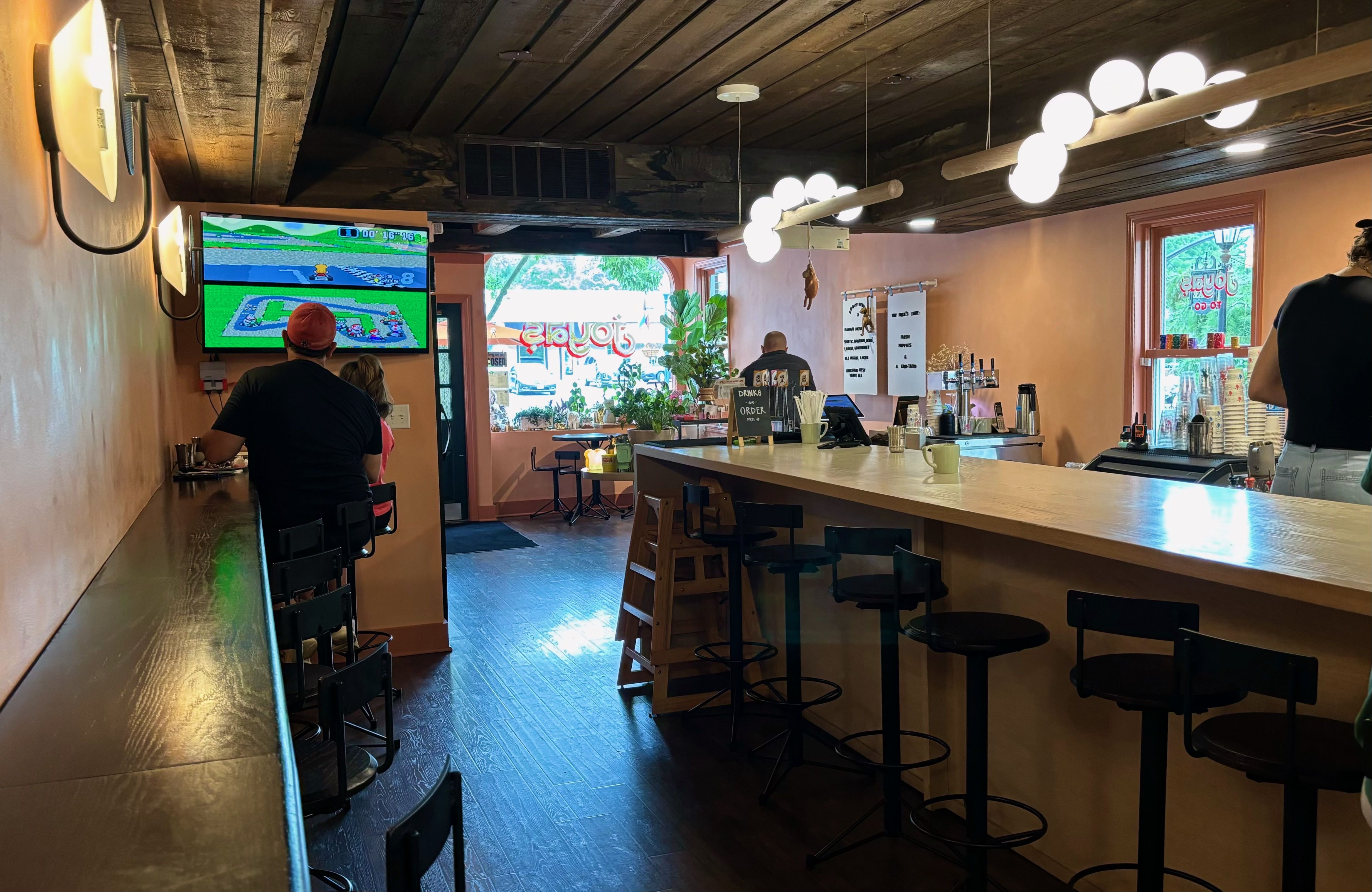 A view of the Joyas restaurant cafe, with barstools and customers eating. 
