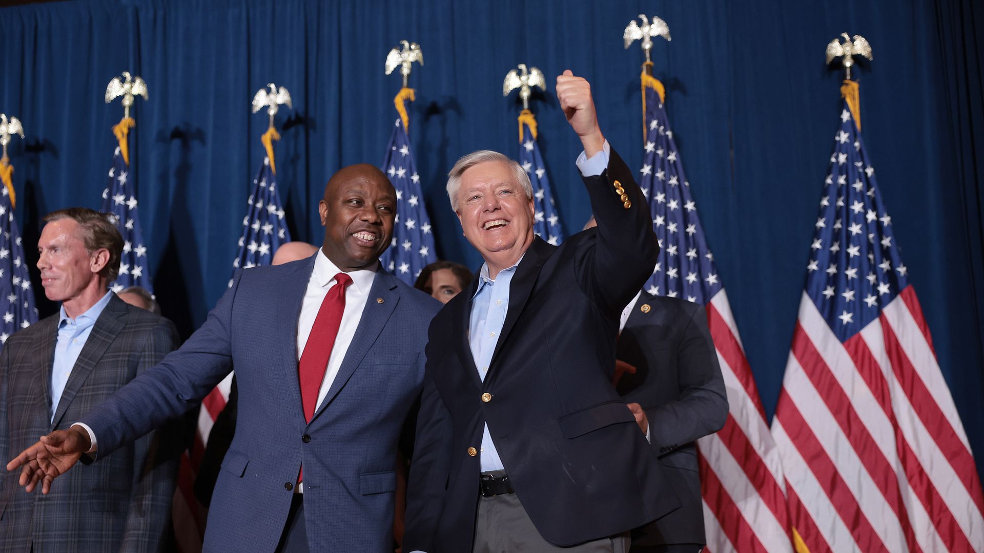 Sen. Tim Scott (R-SC) and Sen. Lindsey Graham (R-SC) cheer on Republican presidential candidate and former President Donald Trump speaks during an election night watch party at the State Fairgrounds on February 24, 2024 in Columbia, South Carolina.