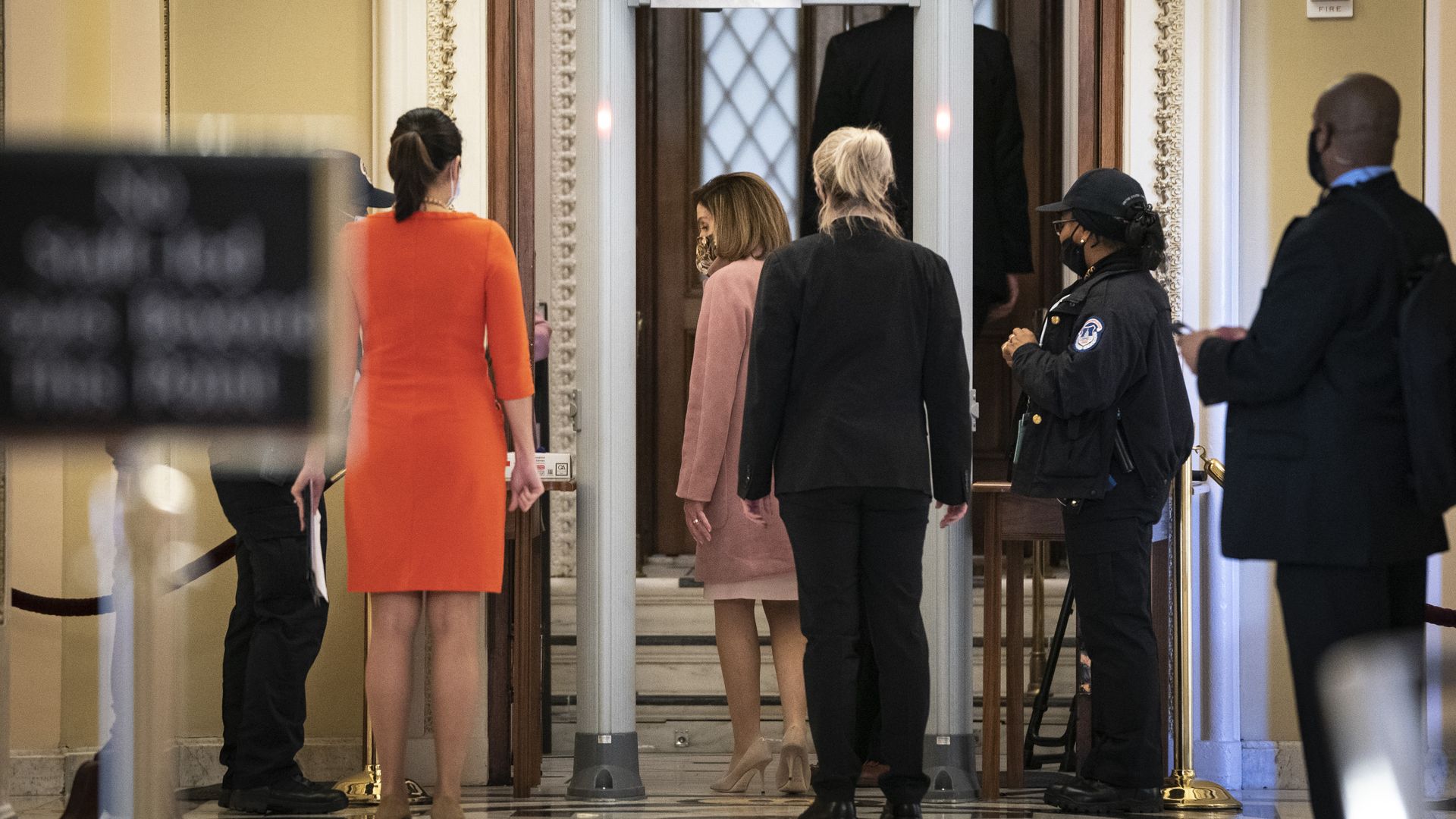 Speaker Nancy Pelosi is seen walking through a newly installed metal detector before entering the House floor.