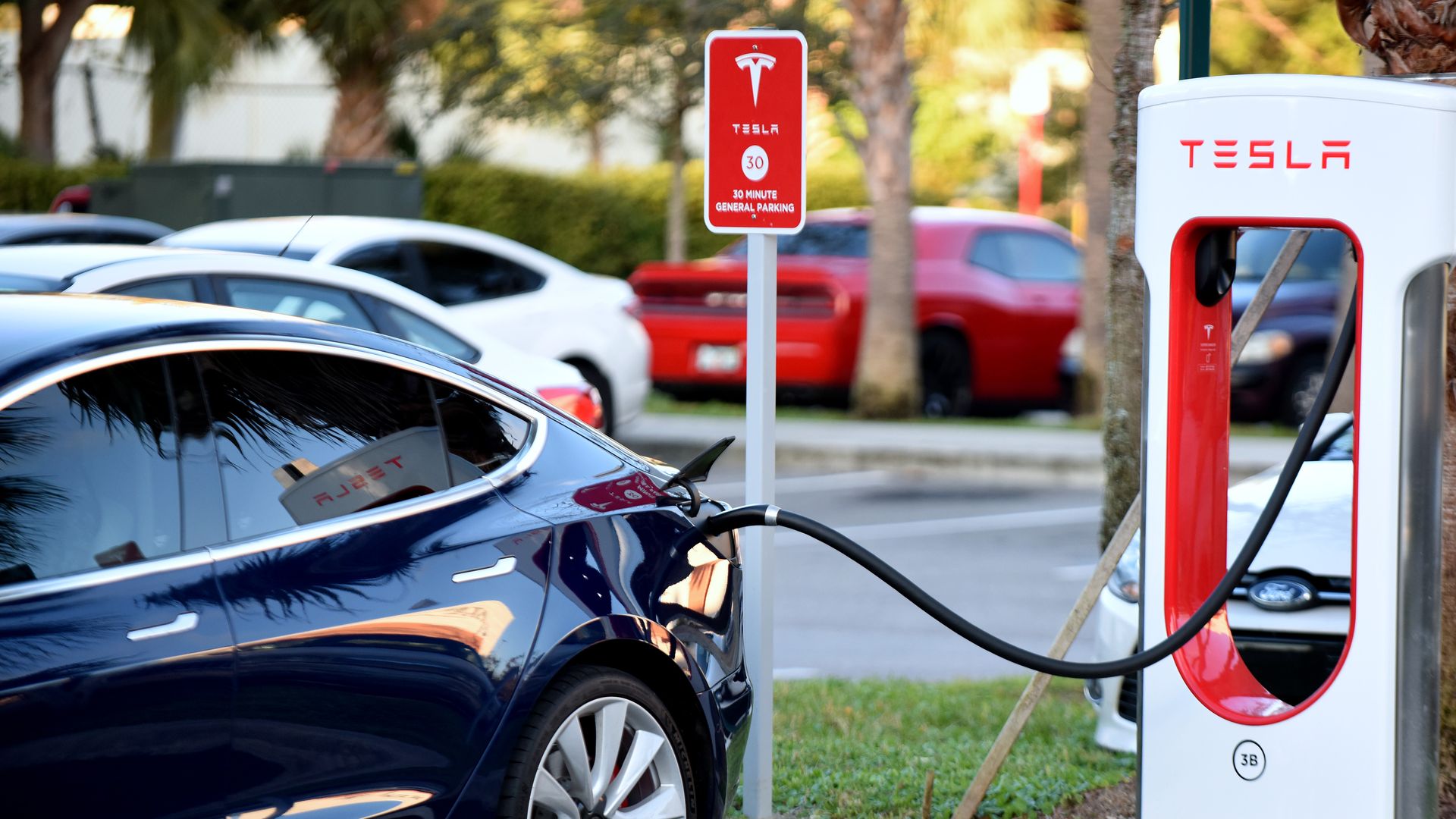 Photo of Tesla charging in a parking lot