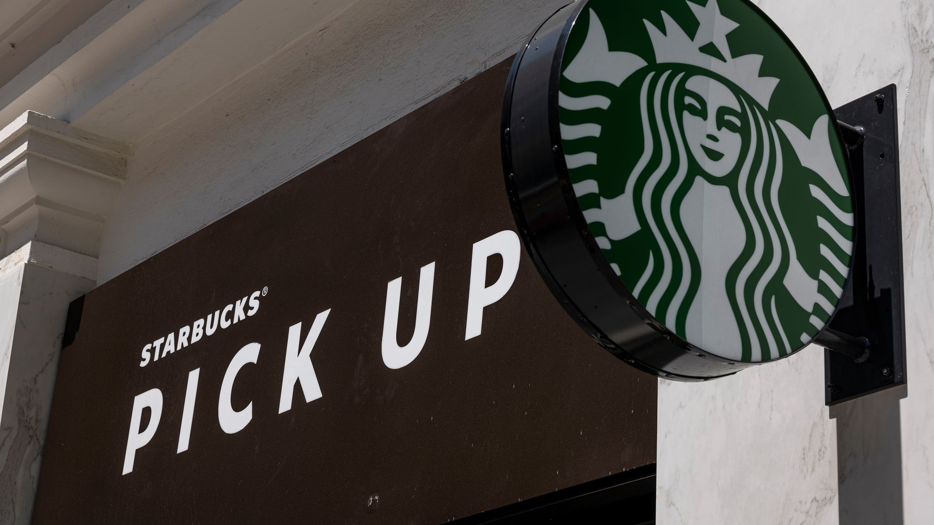 Starbucks logo outside a pickup store sign