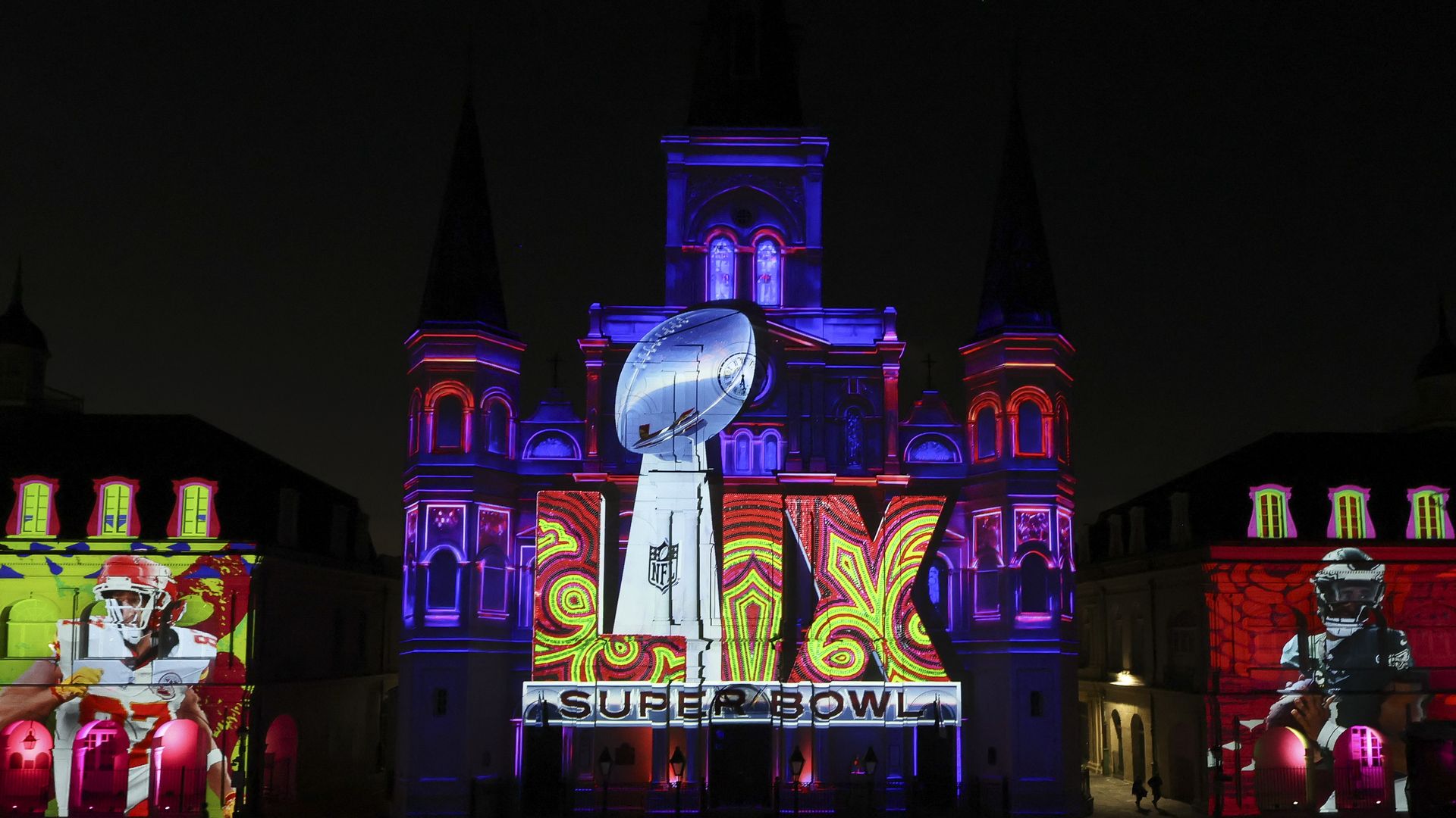 photo at night of the Super Bowl LIX logo projected onto jackson square in new orleans