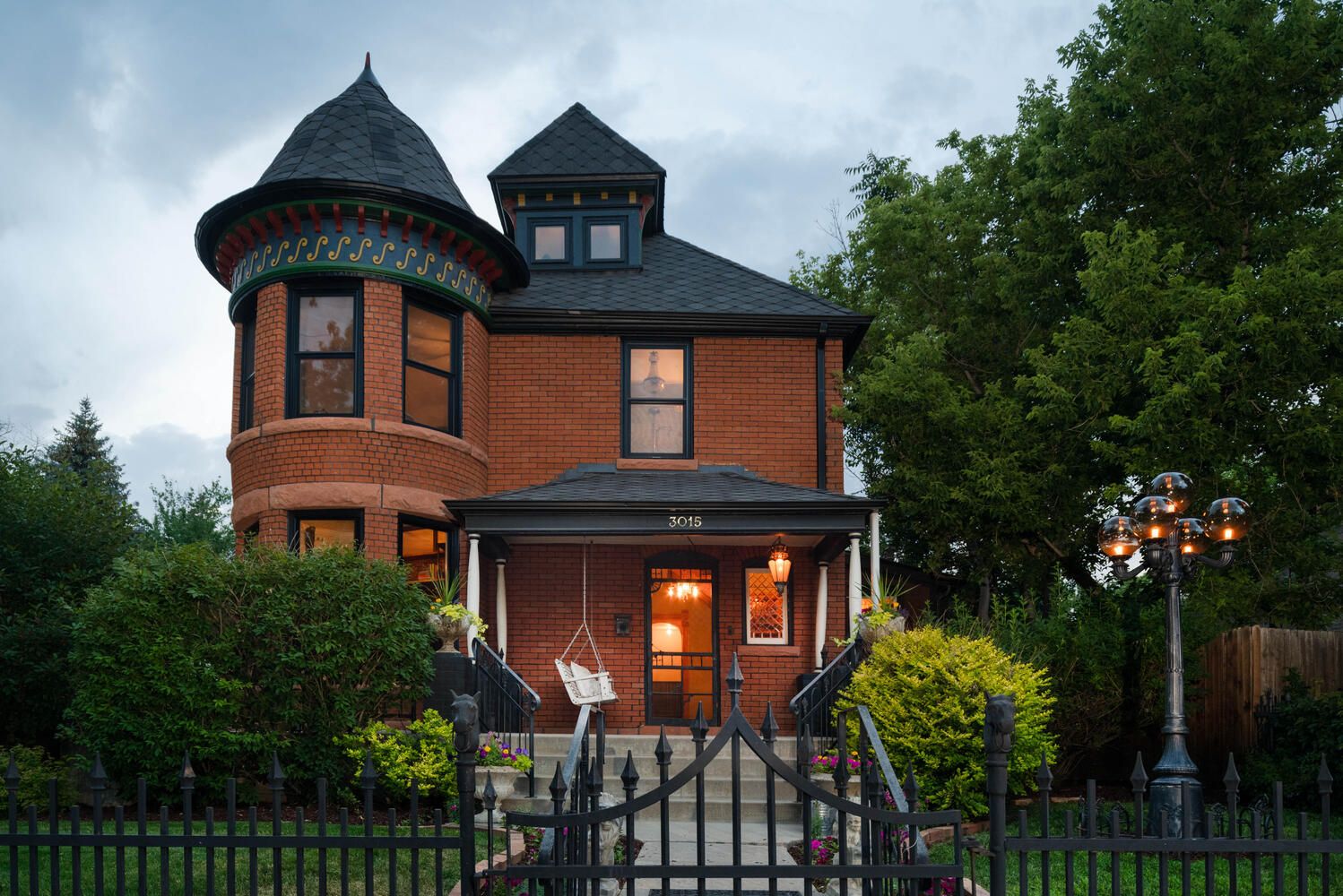 A photo of the front of a Victorian red-bricked home