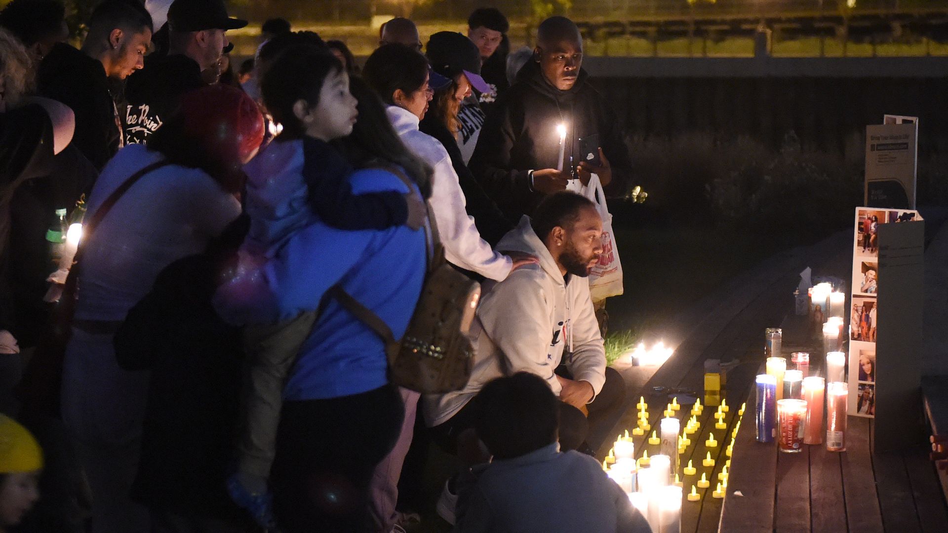 Mourners hold candles at a vigil in St. Paul