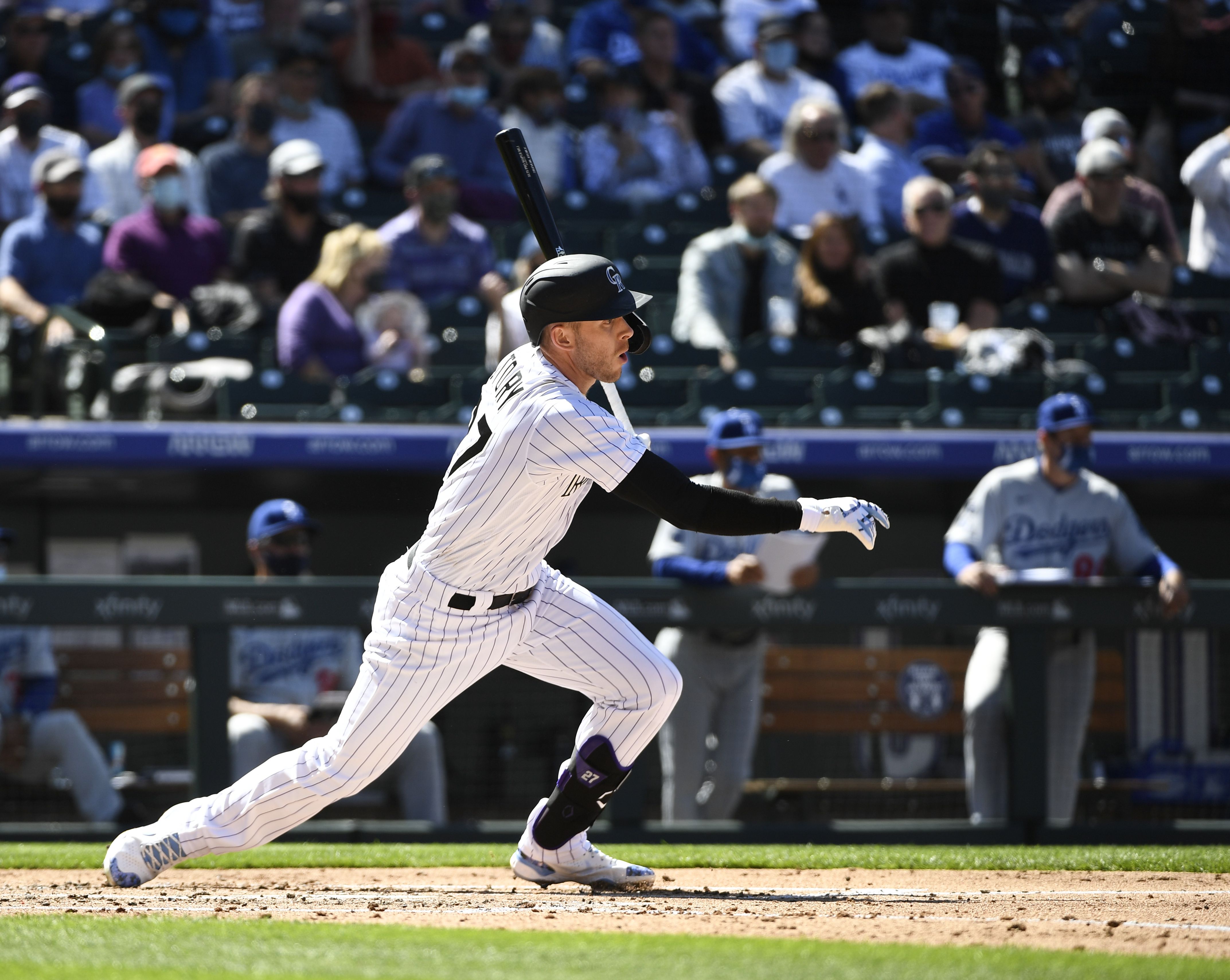<INSERT PHOTO> In the 2021 opener, Trevor Story hits a single as masked fans watch on. In the first home opener since the pandemic-shortened 2020 season, the Rockies trumped defending World Series champion L.A. Dodgers 8-5. Photo: Andy Cross/Denver Post via Getty Images